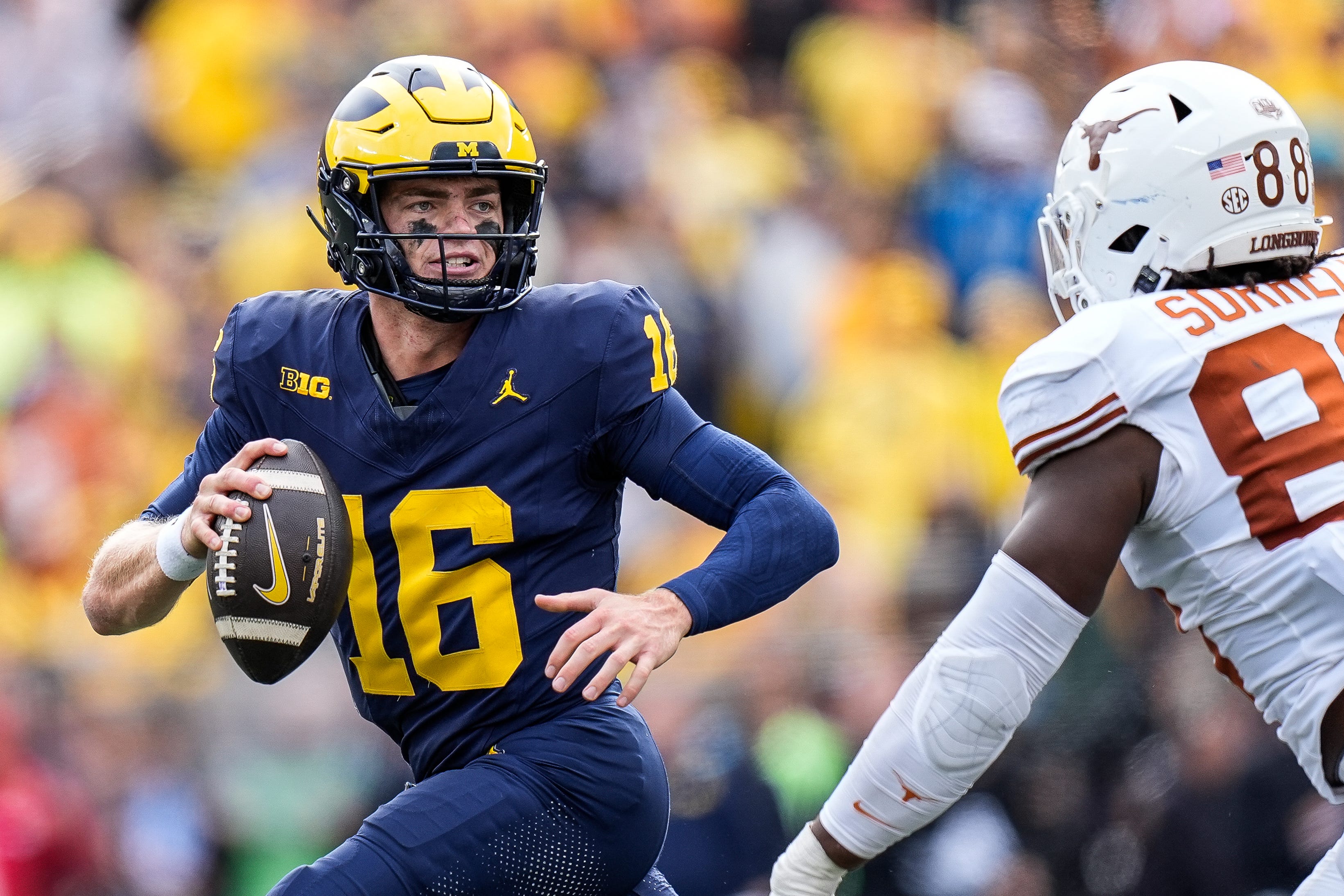 Michigan quarterback Davis Warren (16) looks to makes a pass against Texas linebacker Barryn Sorrell (88) during the second half at Michigan Stadium in Ann Arbor on Saturday, September 7, 2024.