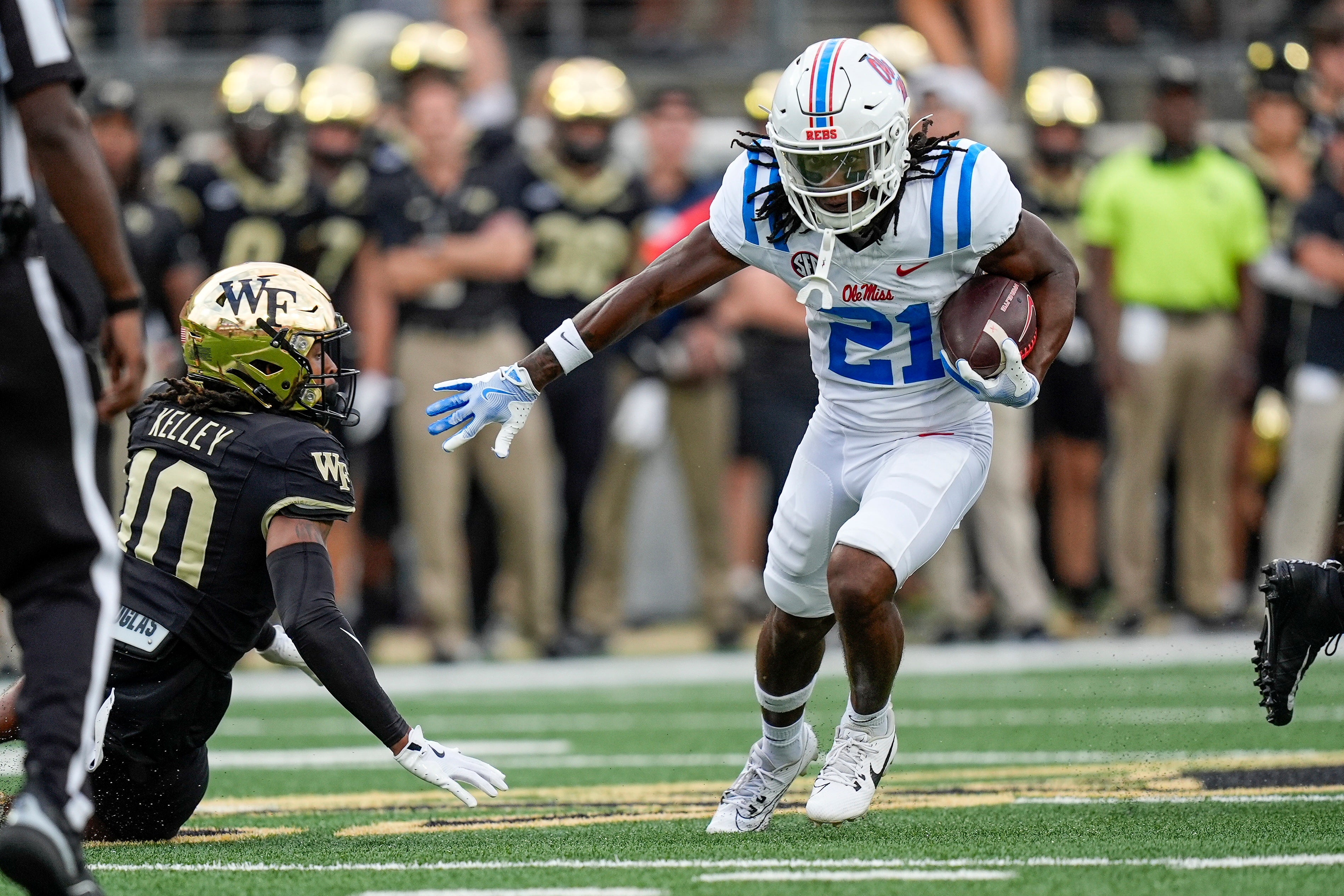 Sep 14, 2024; Winston-Salem, North Carolina, USA; Mississippi Rebels running back Henry Parrish Jr. (21) avoids Wake Forest Demon Deacons defensive back C'Darius Kelley (10) during the first half at Allegacy Federal Credit Union Stadium.