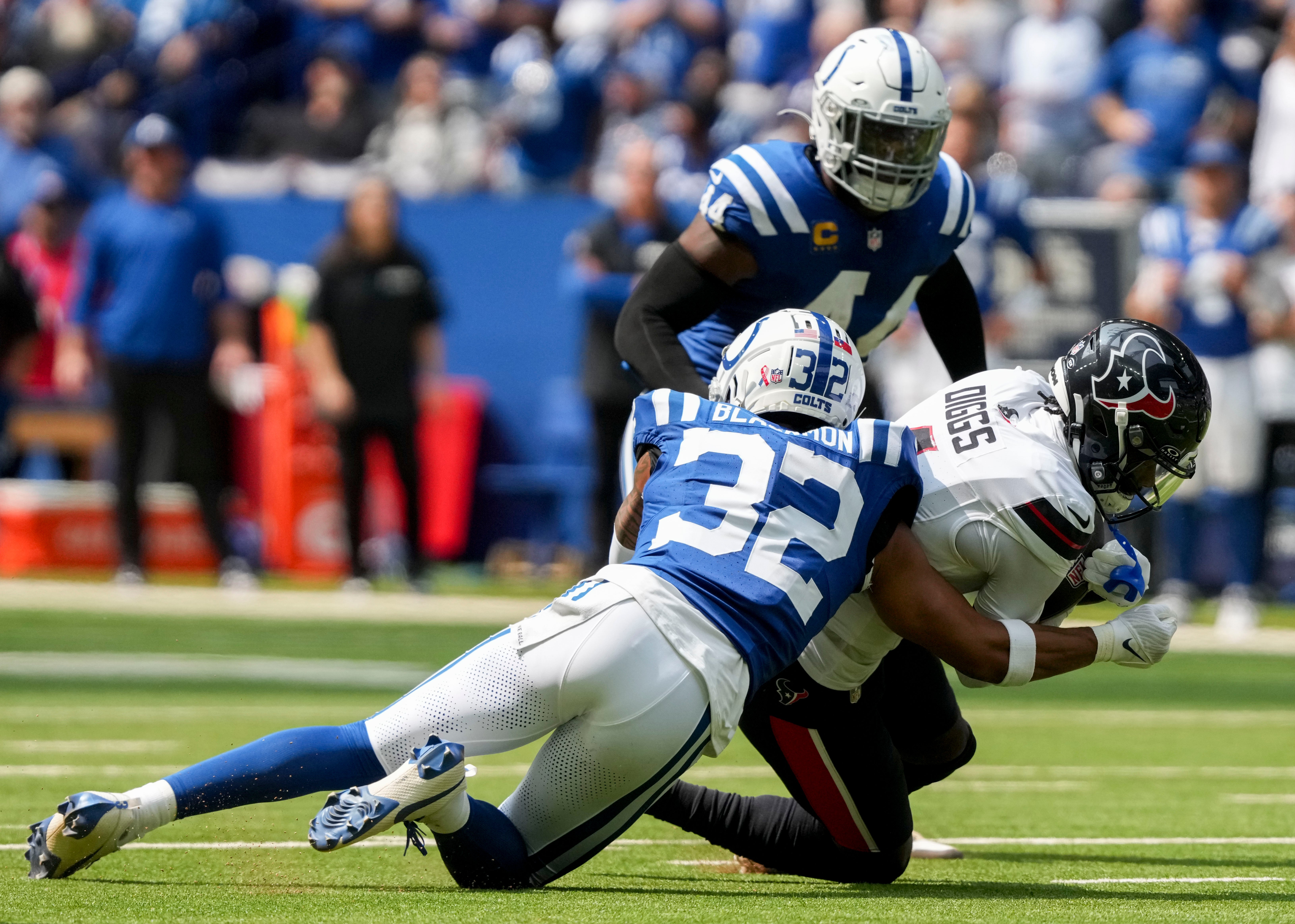 Sep 8, 2024; Indianapolis, Indiana, USA; Indianapolis Colts safety Julian Blackmon (32) tackles Houston Texans wide receiver Stefon Diggs (1) at Lucas Oil Stadium.