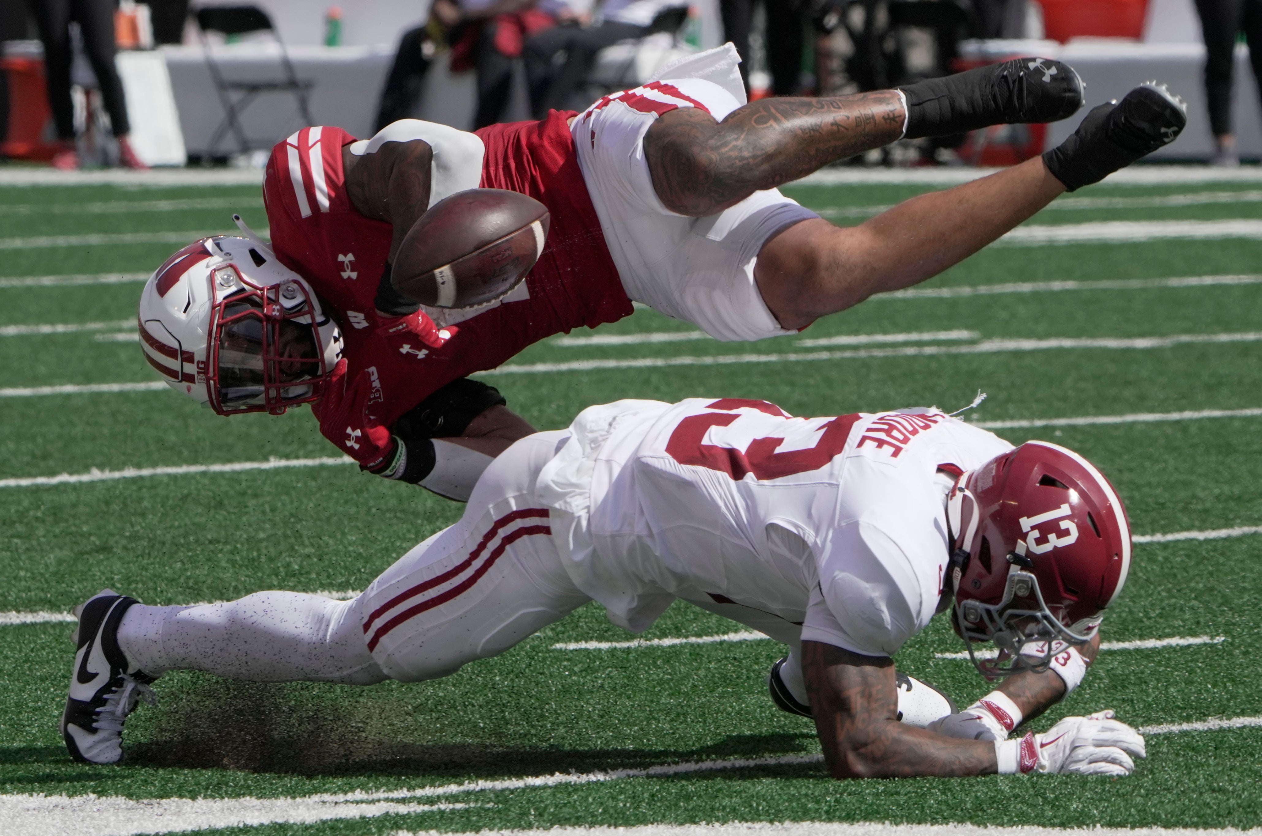 Sep 14, 2024; Madison, Wisconsin, USA; Wisconsin Bulldogs running back Chez Mellusi (1) fumbles the ball after being hit by Alabama Crimson Tide defensive back Malachi Moore (13) during the second quarter at Camp Randall Stadium. Alabama recovered the ball. Mandatory Credit: Mark Hoffman/USA TODAY Network via Imagn Images  
