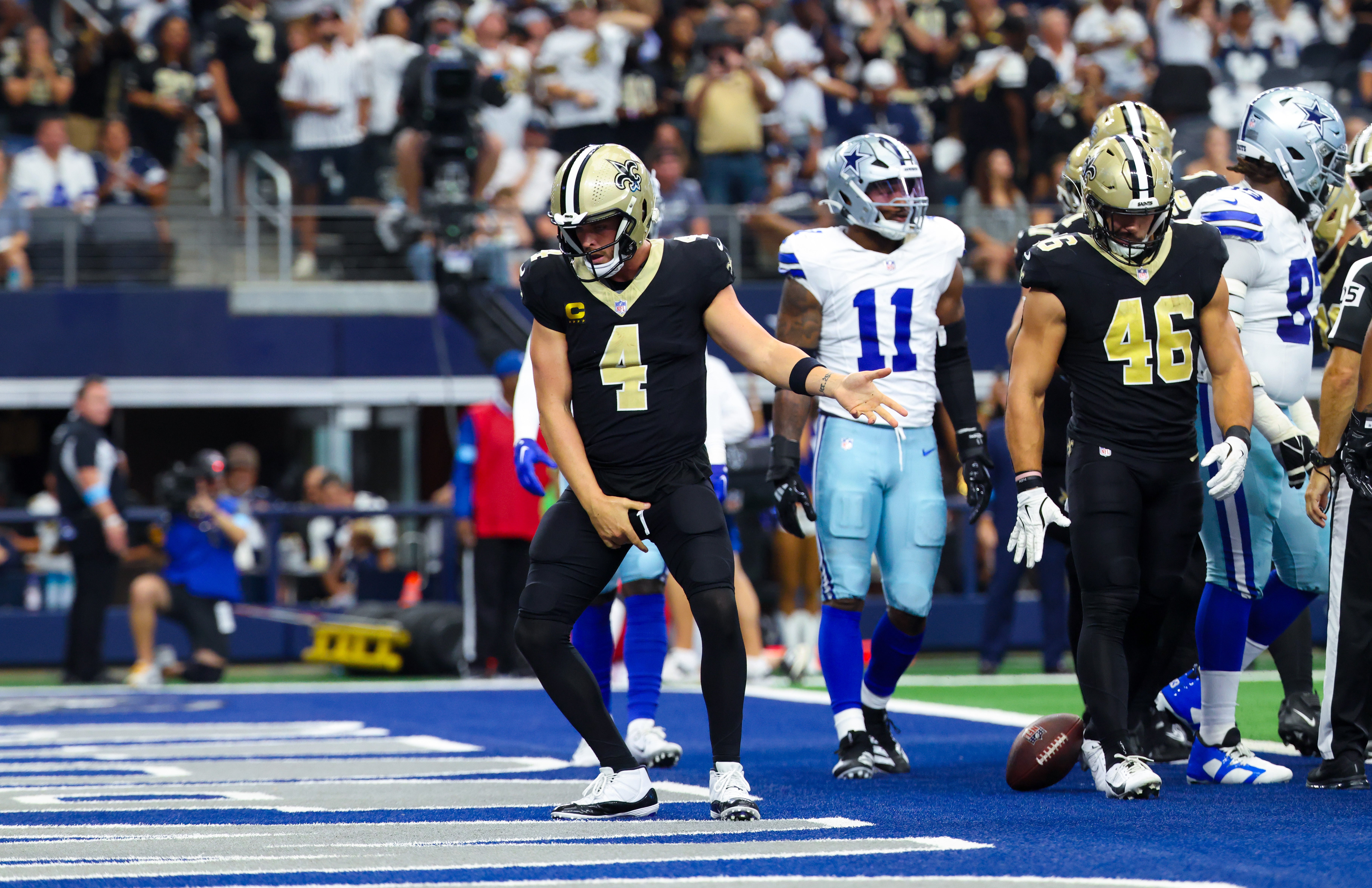 New Orleans Saints quarterback Derek Carr (4) celebrates after scoring a touchdown during the first half against the Dallas Cowboys at AT&T Stadium.