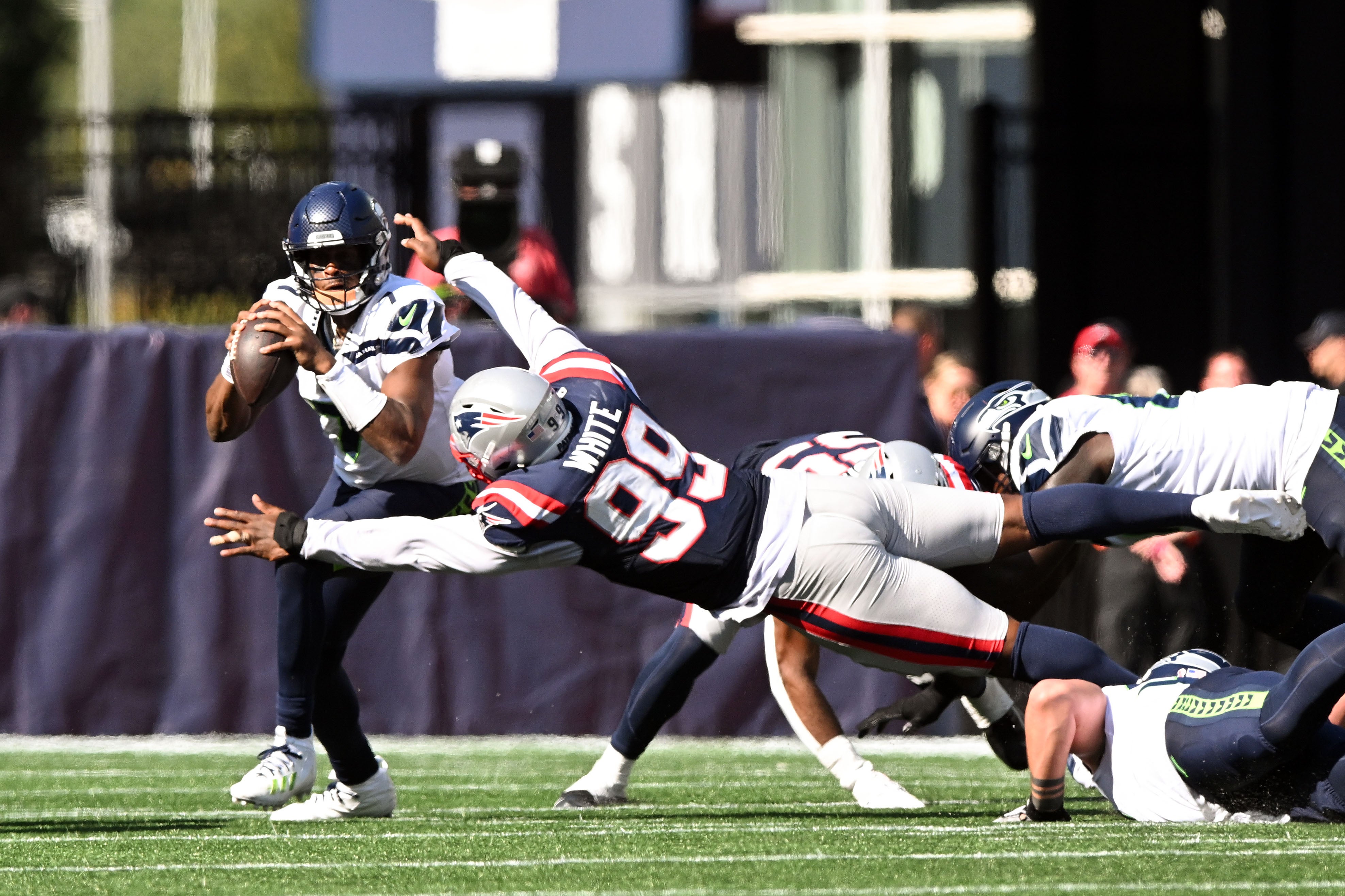 Sep 15, 2024; Foxborough, Massachusetts, USA; New England Patriots defensive end Keion White (99) sacks Seattle Seahawks quarterback Geno Smith (7) during the second half at Gillette Stadium.