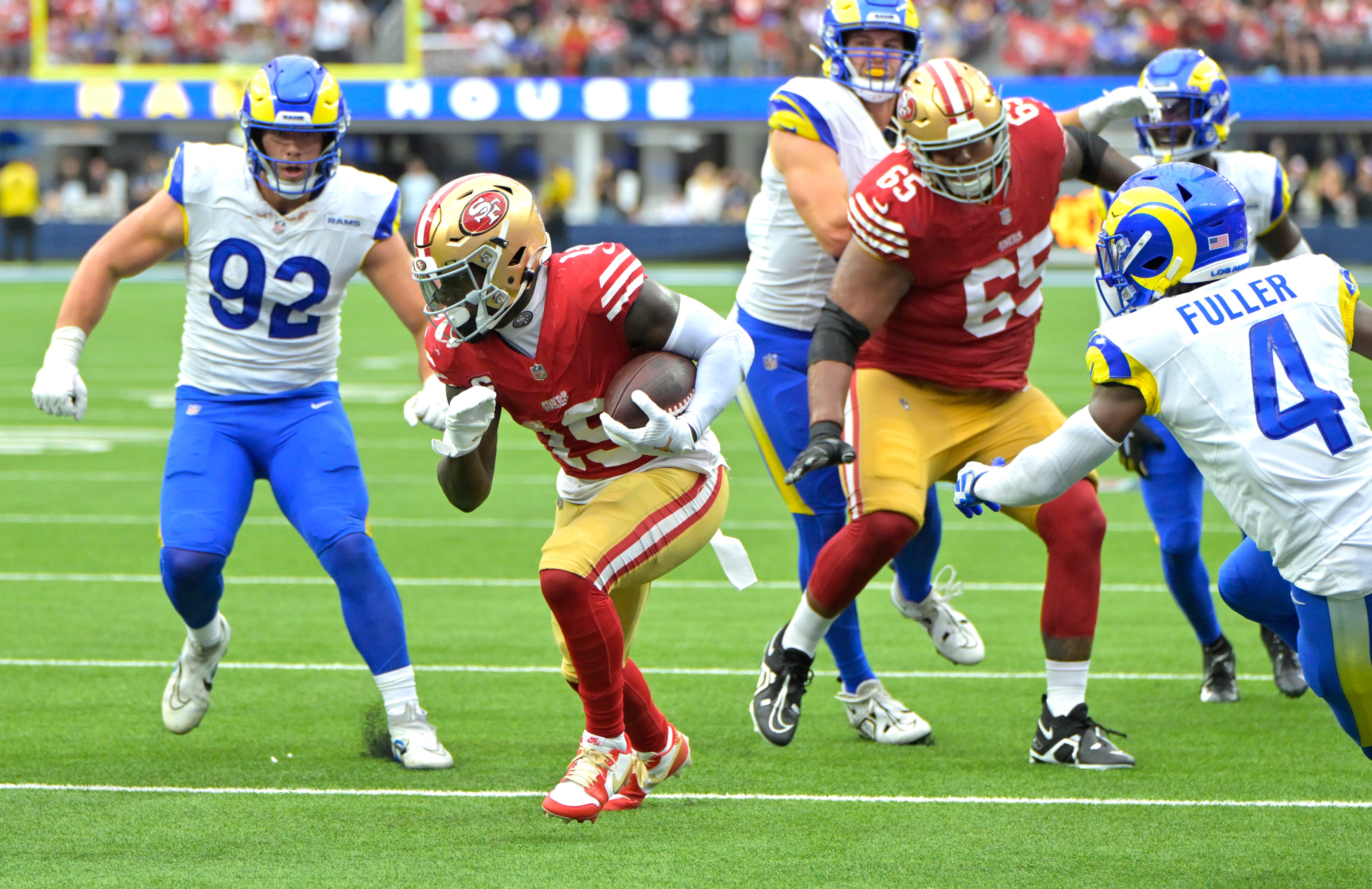 Sep 17, 2023; Inglewood, California, USA; San Francisco 49ers wide receiver Deebo Samuel (19) runs through the Los Angeles Rams defense for a touchdown in the second half at SoFi Stadium.