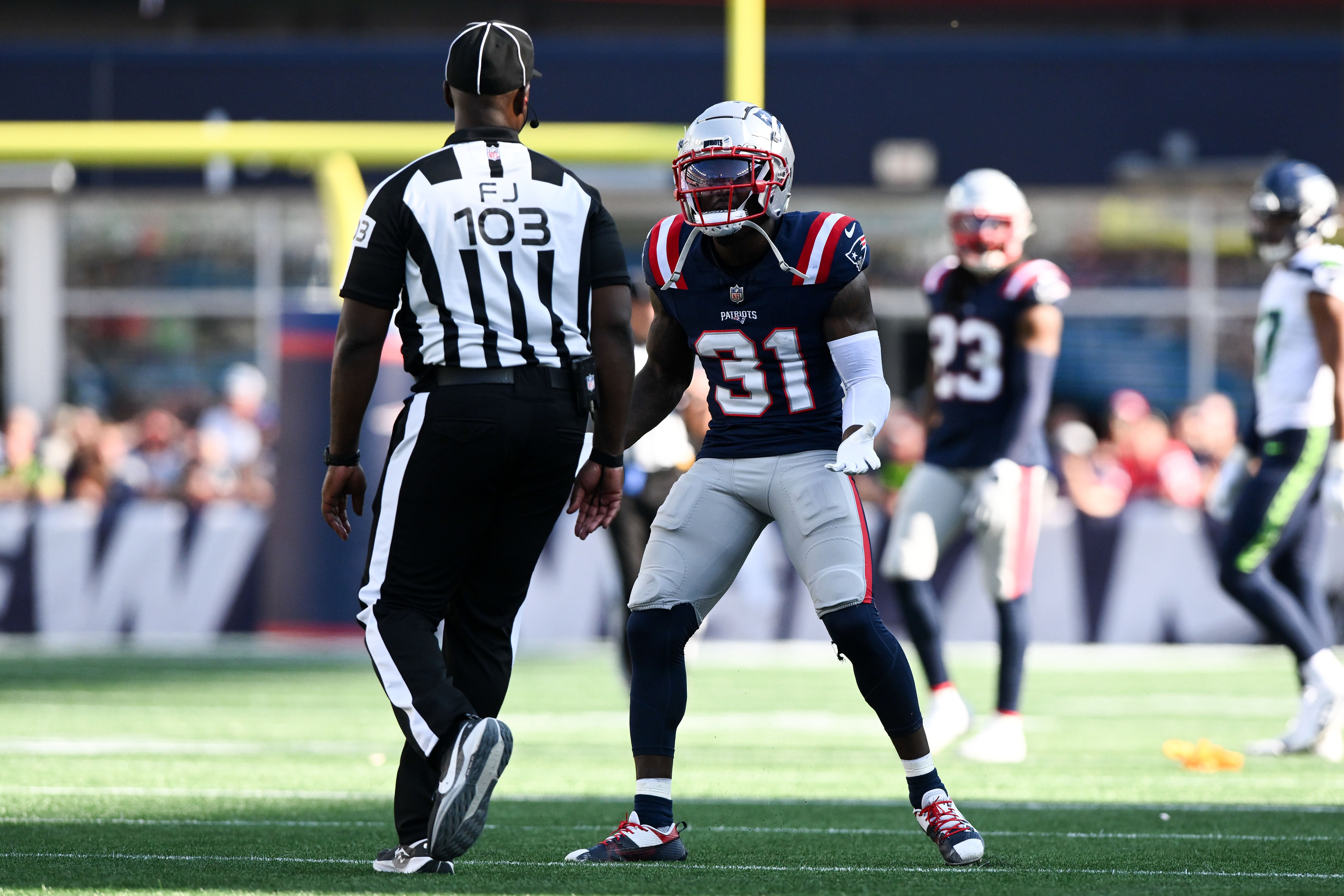 Sep 15, 2024; Foxborough, Massachusetts, USA; New England Patriots cornerback Jonathan Jones (31) argues with side judge Eugene Hall (103) after a pass interference call during overtime against the Seattle Seahawks at Gillette Stadium.