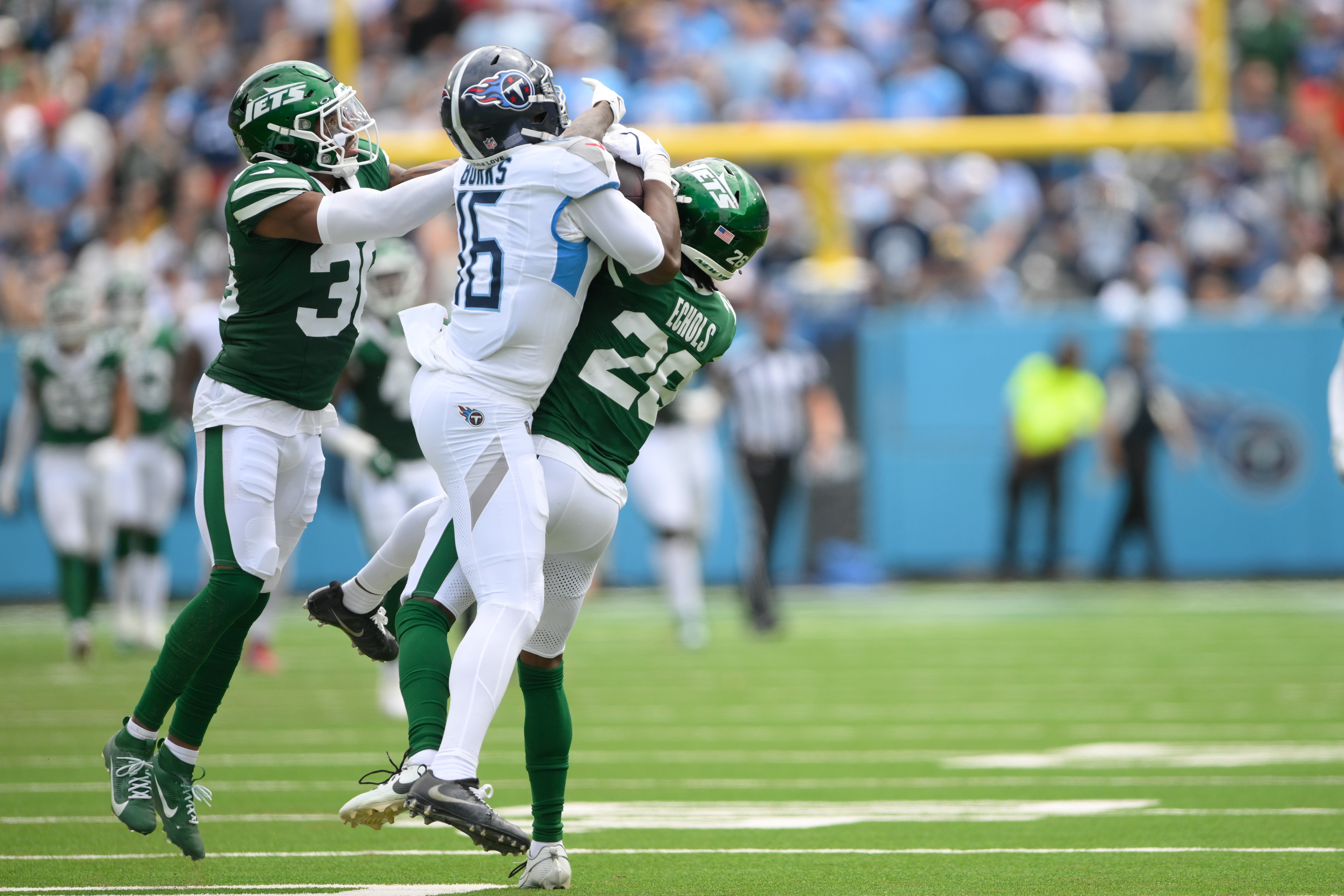 Sep 15, 2024; Nashville, Tennessee, USA; New York Jets running back Breece Hall (20) intercepts the pass thrown to Tennessee Titans wide receiver Treylon Burks (16) during the first half at Nissan Stadium.