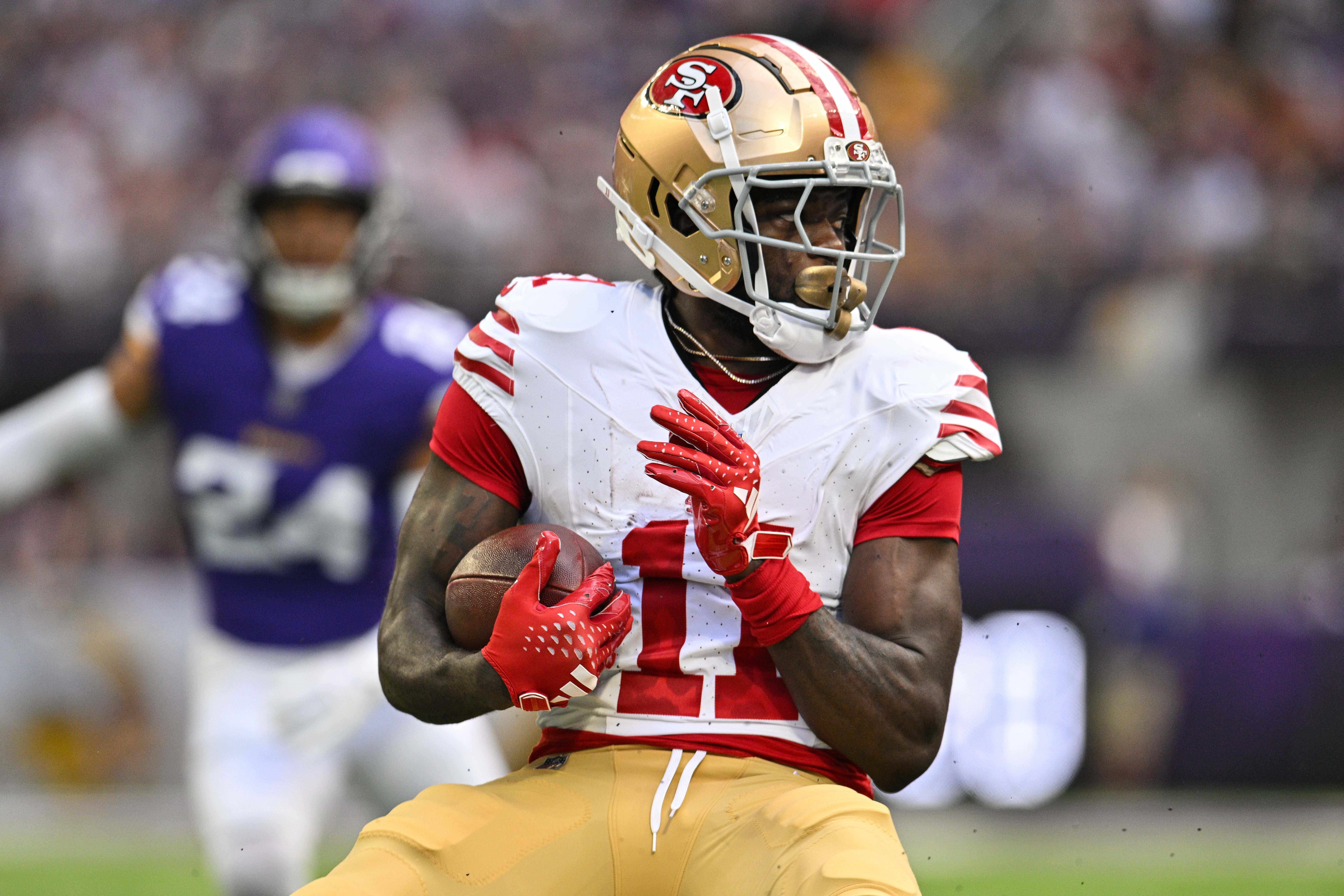 Sep 15, 2024; Minneapolis, Minnesota, USA; San Francisco 49ers wide receiver Brandon Aiyuk (11) looks for yards after the catch against the Minnesota Vikings during the first quarter U.S. Bank Stadium.