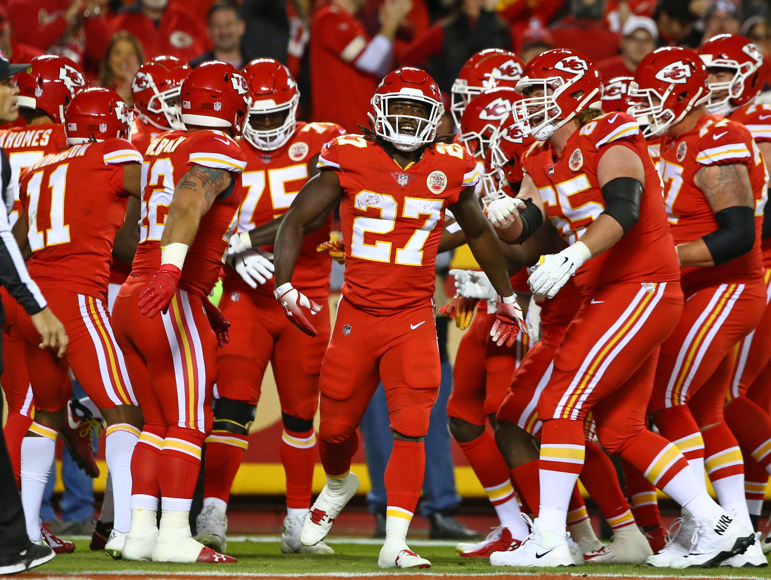 Oct 21, 2018; Kansas City, MO, USA; Kansas City Chiefs running back Kareem Hunt (27) is congratulated by teammates after scoring a touchdown against the Cincinnati Bengals in the first half at Arrowhead Stadium
