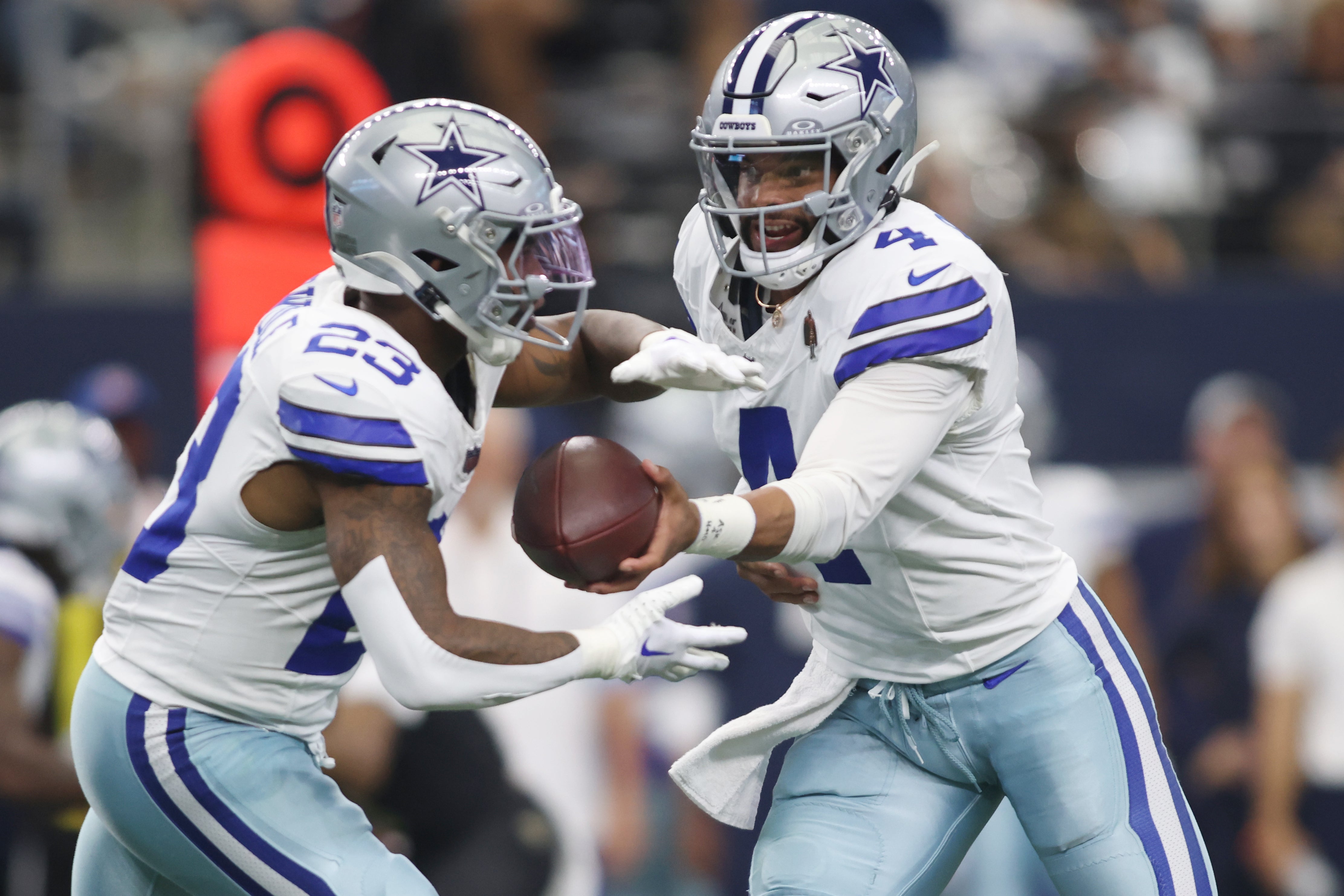 Dallas Cowboys quarterback Dak Prescott (4) hands off to running back Rico Dowdle (23) in the first quarter against the New Orleans Saints at AT&T Stadium.