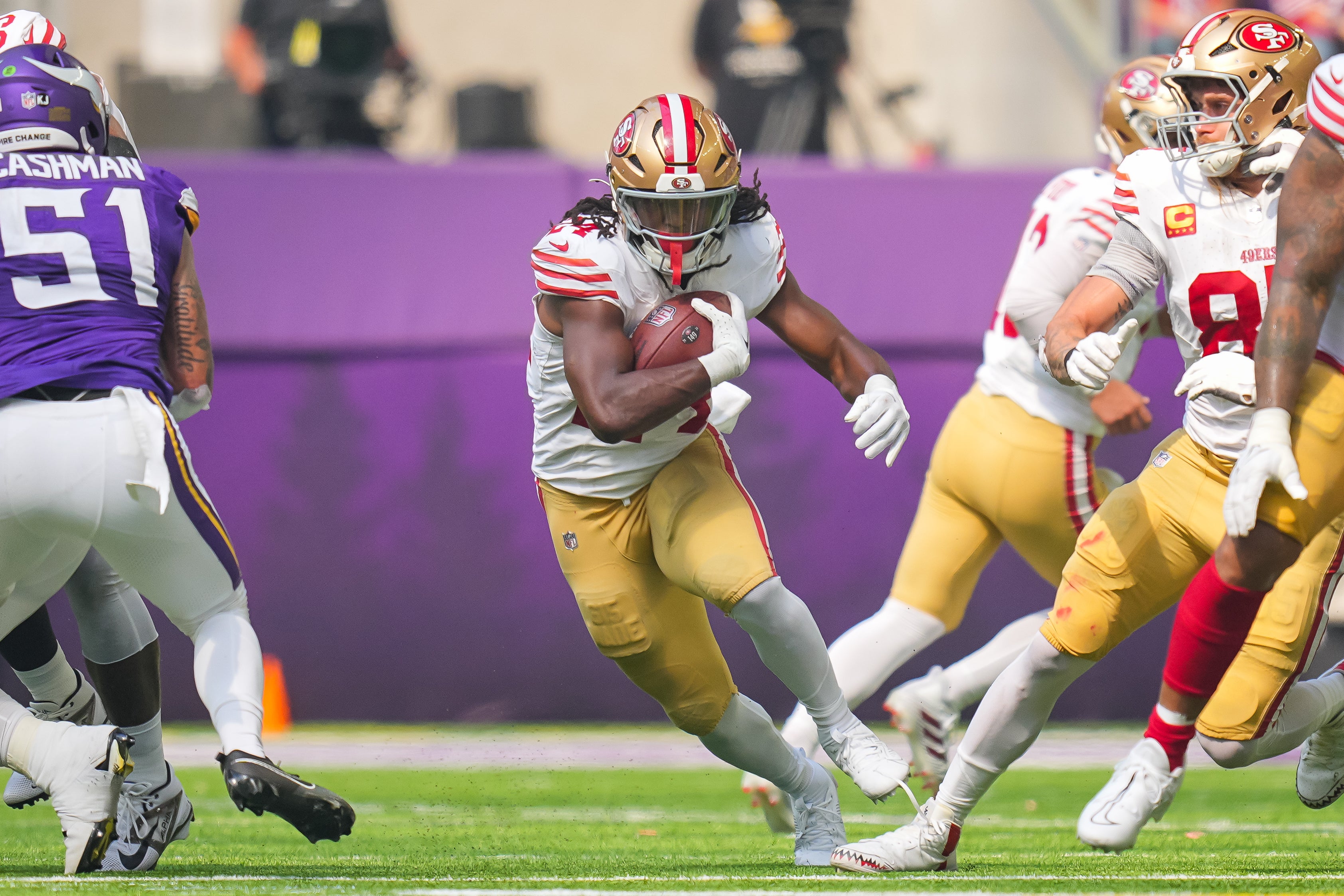 Sep 15, 2024; Minneapolis, Minnesota, USA; San Francisco 49ers running back Jordan Mason (24) runs with the ball against the Minnesota Vikings in the first quarter at U.S. Bank Stadium.