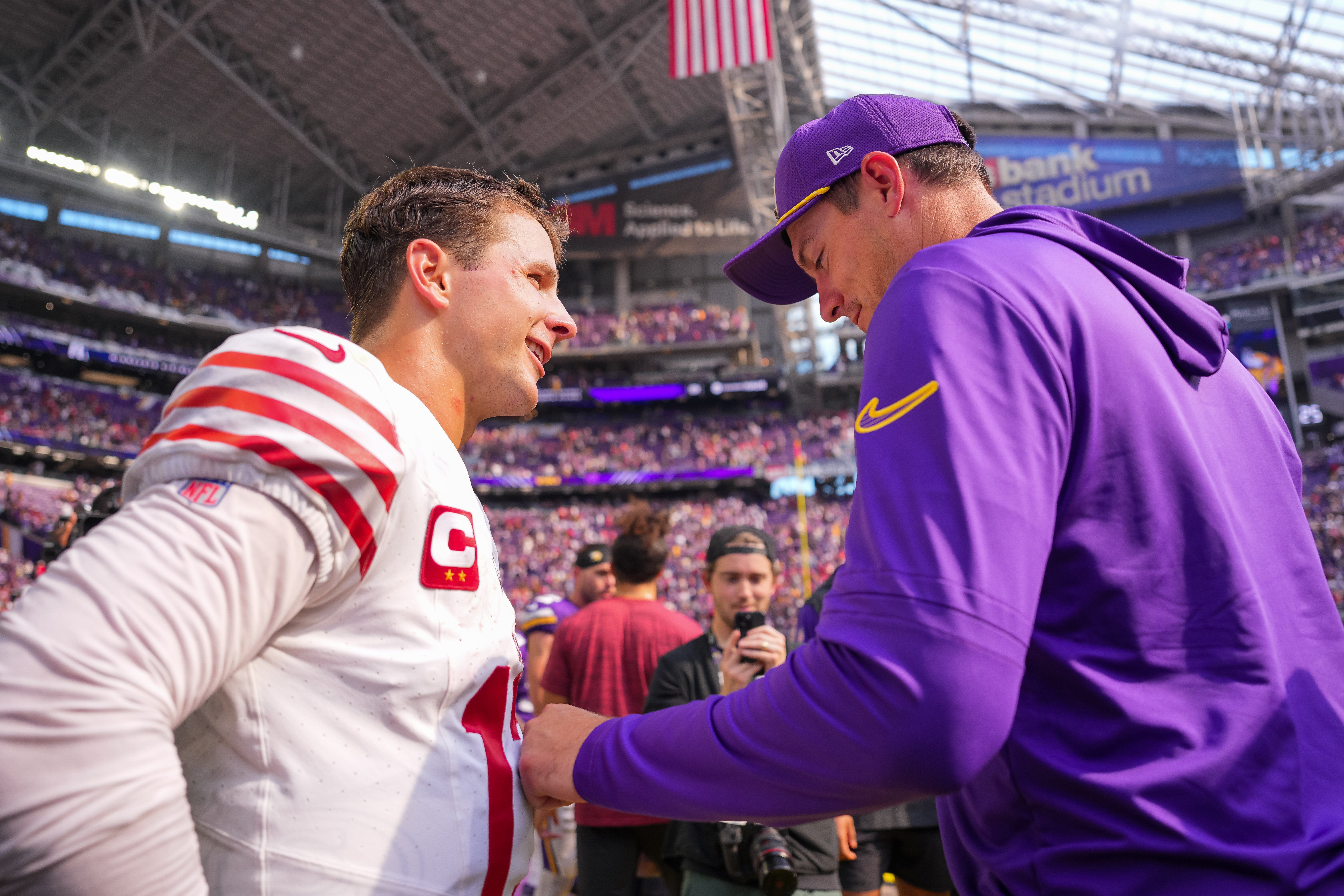 Sep 15, 2024; Minneapolis, Minnesota, USA; San Francisco 49ers quarterback Brock Purdy (13) and Minnesota Vikings head coach Kevin O'Connell talk after the game at U.S. Bank Stadium.