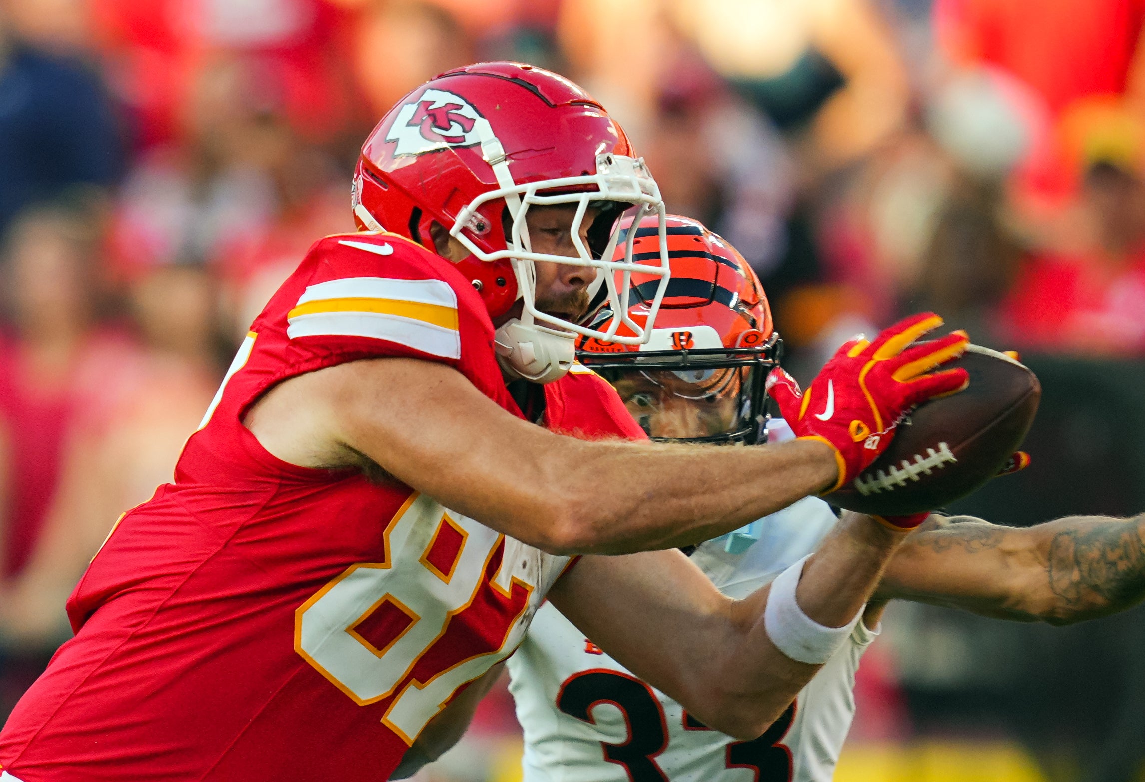 Sep 15, 2024; Kansas City, Missouri, USA; Kansas City Chiefs tight end Travis Kelce (87) catches a pass against Cincinnati Bengals safety Daijahn Anthony (33) during the second half at GEHA Field at Arrowhead Stadium.