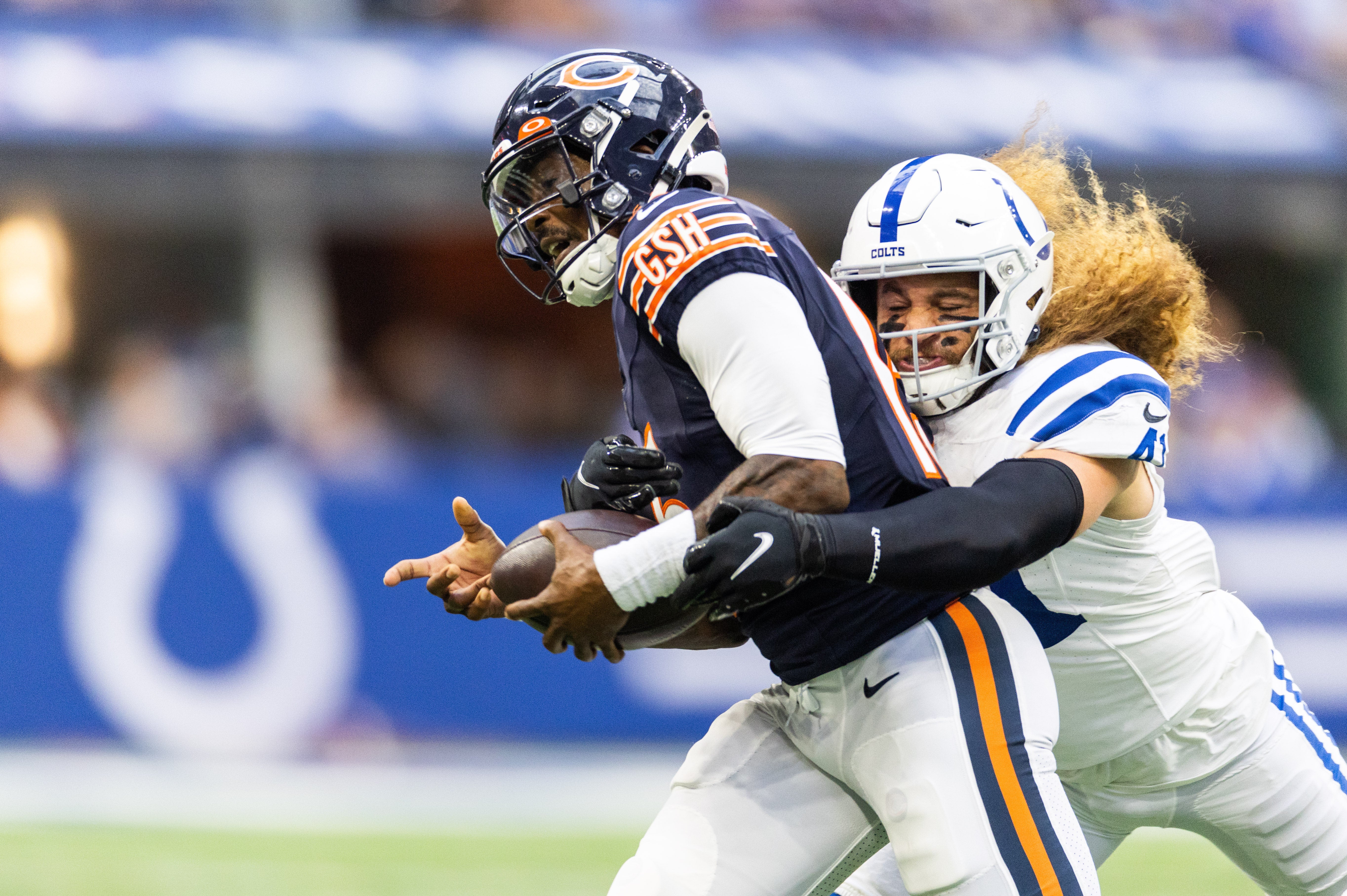 Aug 19, 2023; Indianapolis, Indiana, USA; Indianapolis Colts linebacker Grant Stuard (41) sacks Chicago Bears quarterback PJ Walker (15) in the first quarter at Lucas Oil Stadium.