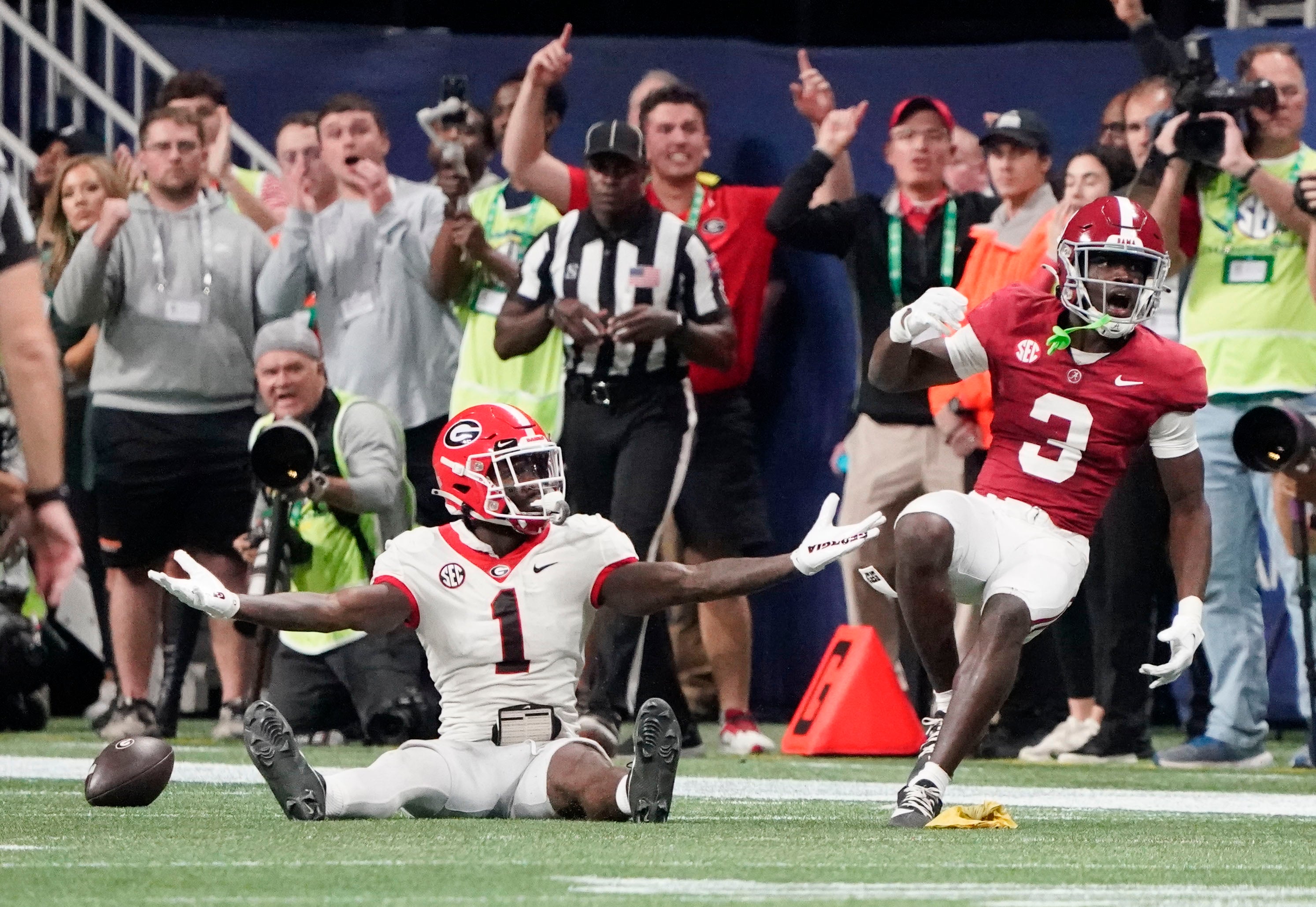 Dec 2, 2023; Atlanta, GA, USA; Georgia Bulldogs wide receiver Marcus Rosemy-Jacksaint (1) and Alabama Crimson Tide defensive back Terrion Arnold (3) look to the official after a flag was thrown for pass interference on Arnold at Mercedes-Benz Stadium. Alabama defeated Georgia 27-24 to claim the SEC Championship. Mandatory Credit: Gary Cosby Jr.-Imagn Images