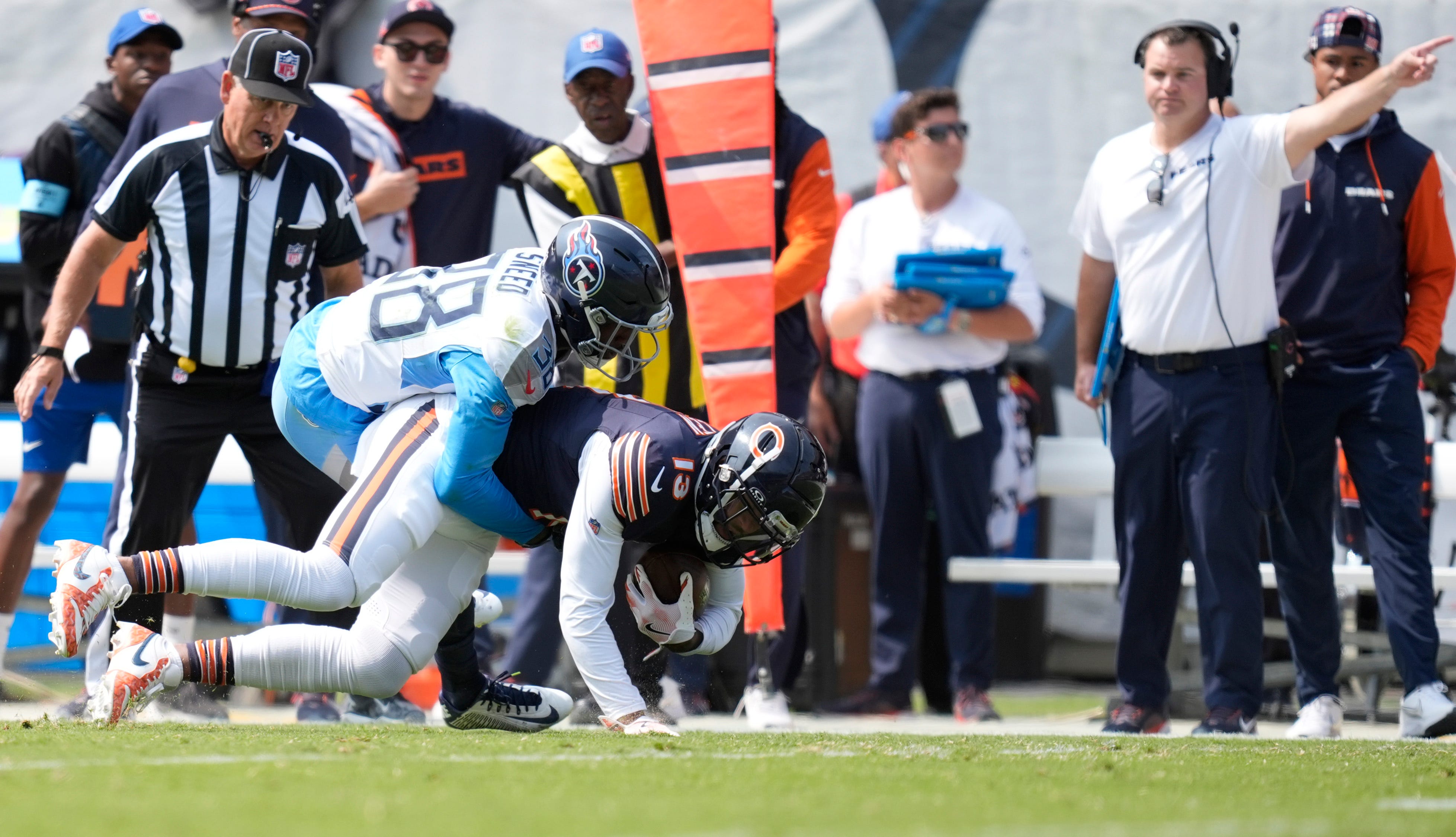 Tennessee Titans cornerback L'Jarius Sneed (38) tackles Chicago Bears wide receiver Keenan Allen (13) for a first down in the first quarter of their game at Soldier Field in Chicago, Ill., Sunday, Sept. 8, 2024.