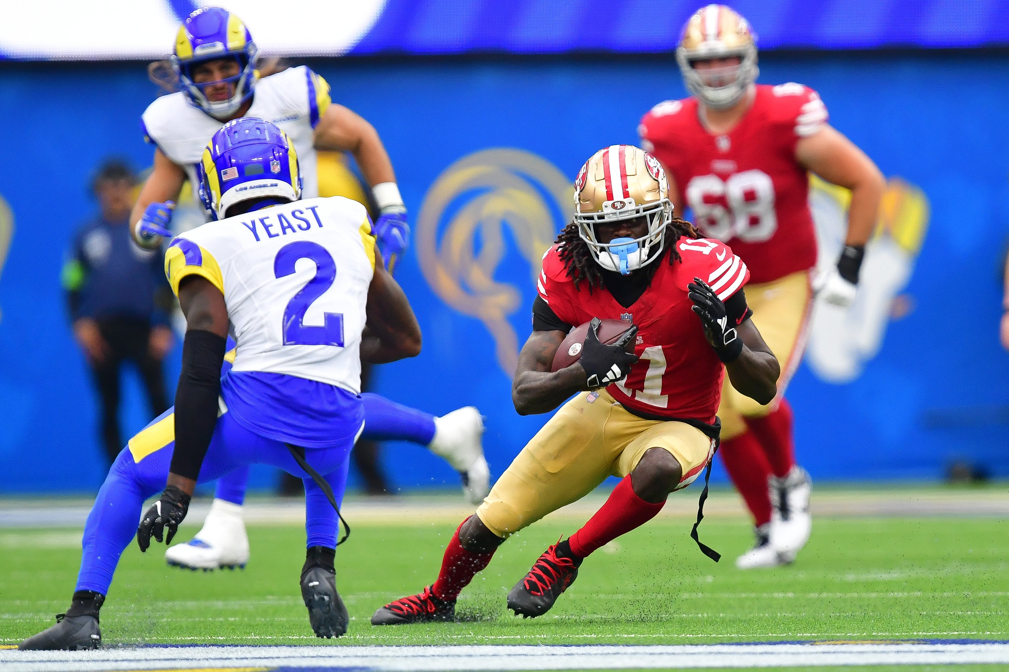 Sep 17, 2023; Inglewood, California, USA; San Francisco 49ers wide receiver Brandon Aiyuk (11) runs the ball against Los Angeles Rams safety Russ Yeast (2) during the second half at SoFi Stadium.