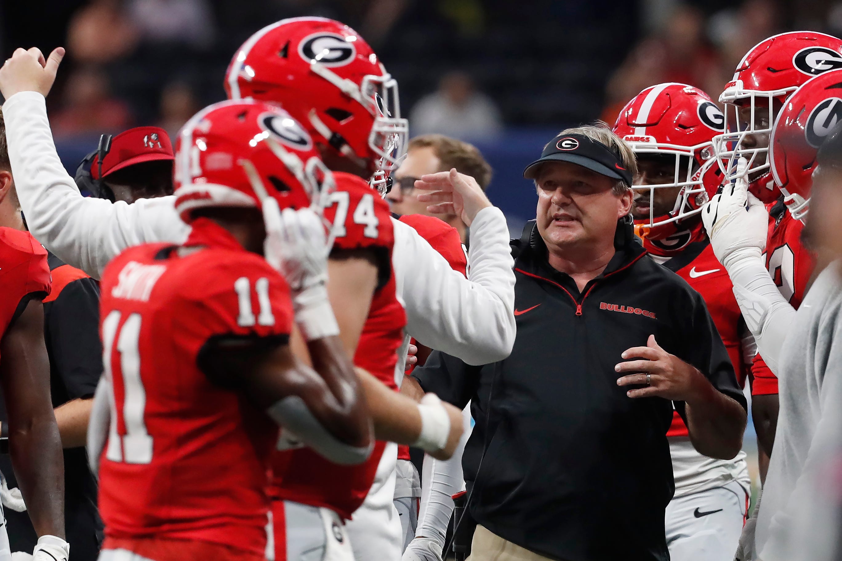 Georgia coach Kirby Smart speaks with his team during the first half of the NCAA Aflac Kickoff Game against Clemson in Atlanta, on Saturday, Aug. 31, 2024.