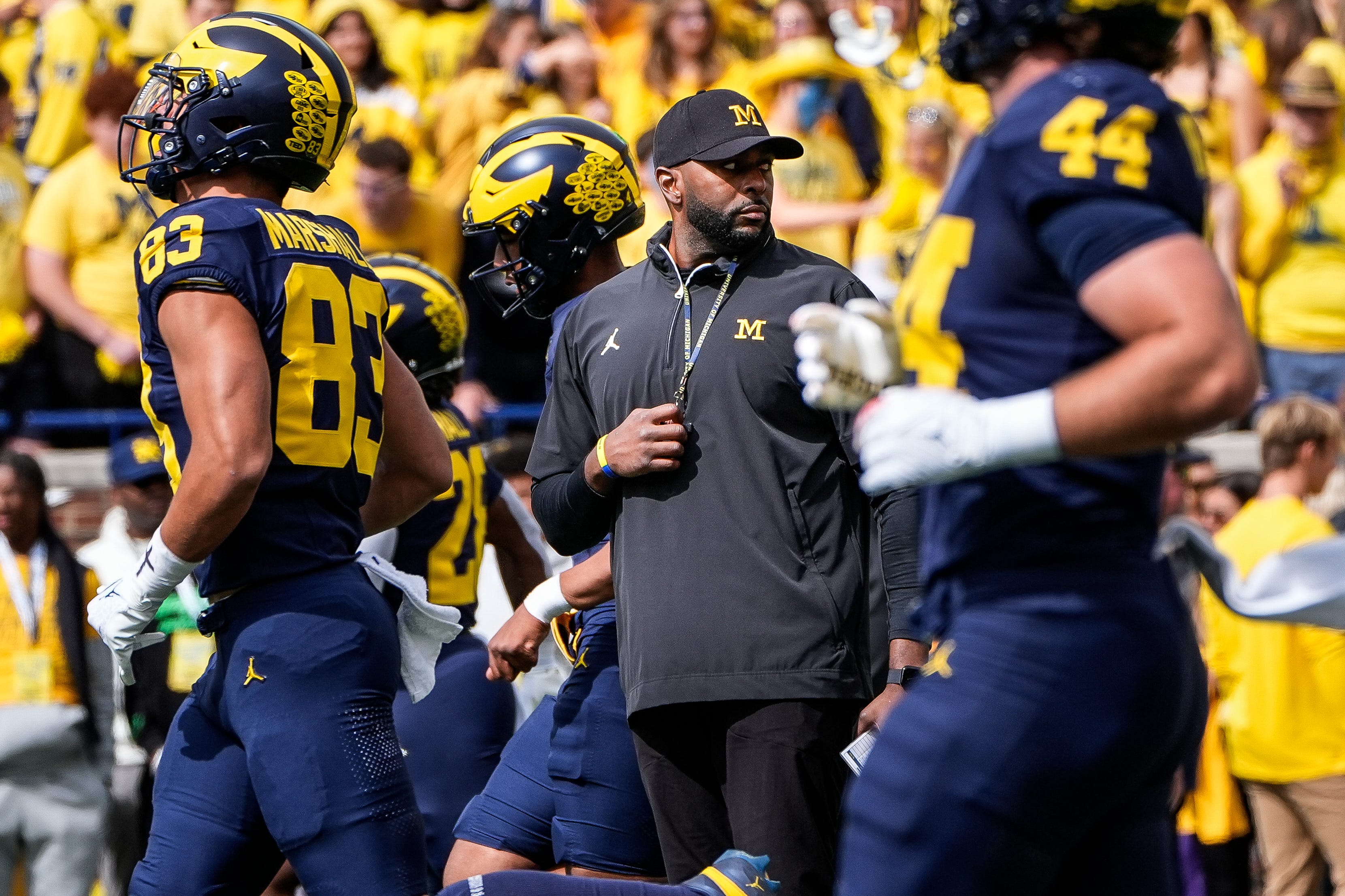 Michigan head coach Sherrone Moore, center, watches warmups before the No. 9 Wolverines' 31-12 loss to No. 3 Texas at Michigan Stadium in Ann Arbor on Saturday, Sept. 7, 2024.