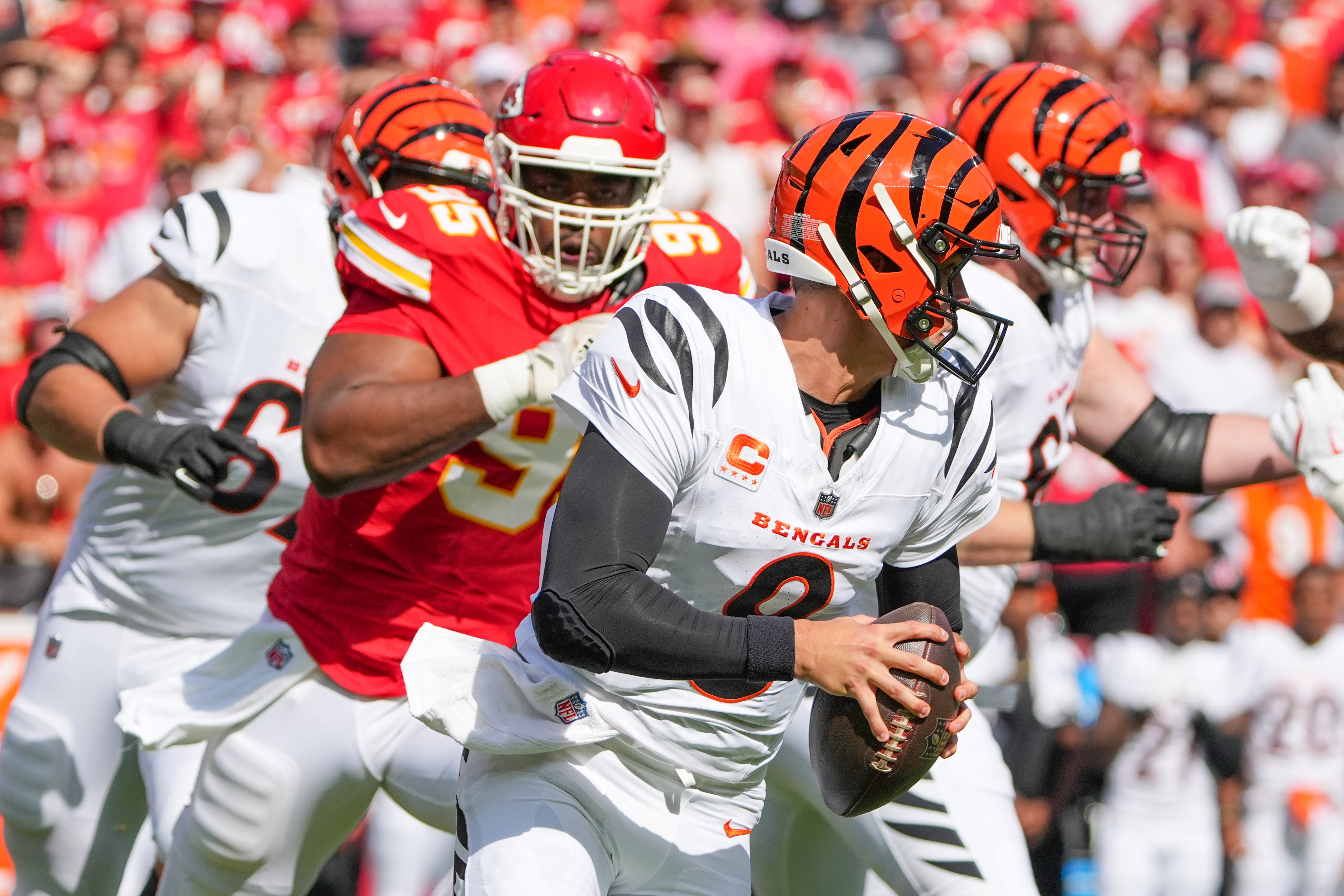 Sep 15, 2024; Kansas City, Missouri, USA; Cincinnati Bengals quarterback Joe Burrow (9) scrambles as Kansas City Chiefs defensive tackle Chris Jones (95) chases during the first half at GEHA Field at Arrowhead Stadium.