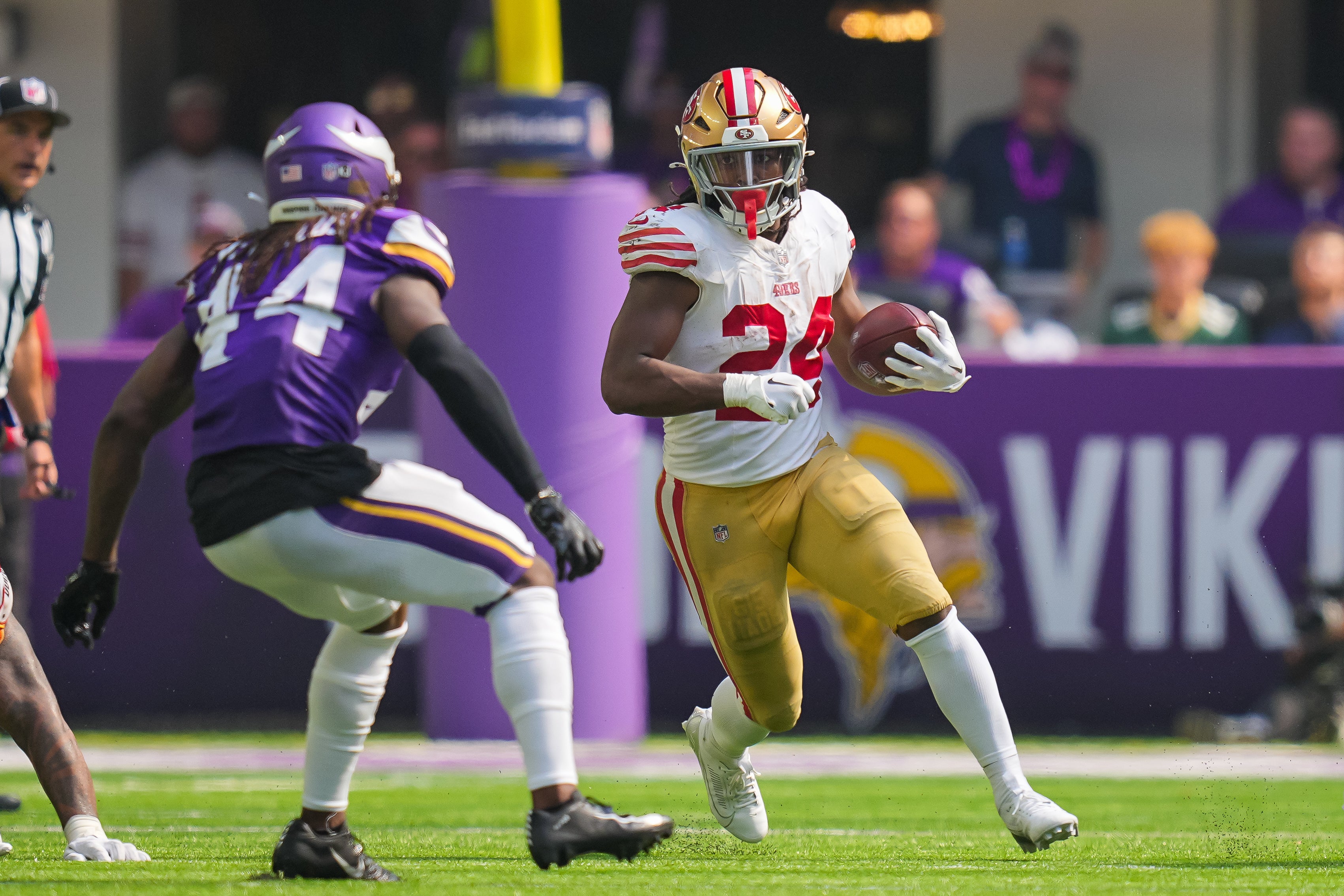 Sep 15, 2024; Minneapolis, Minnesota, USA; San Francisco 49ers running back Jordan Mason (24) runs with the ball against the Minnesota Vikings in the third quarter at U.S. Bank Stadium.