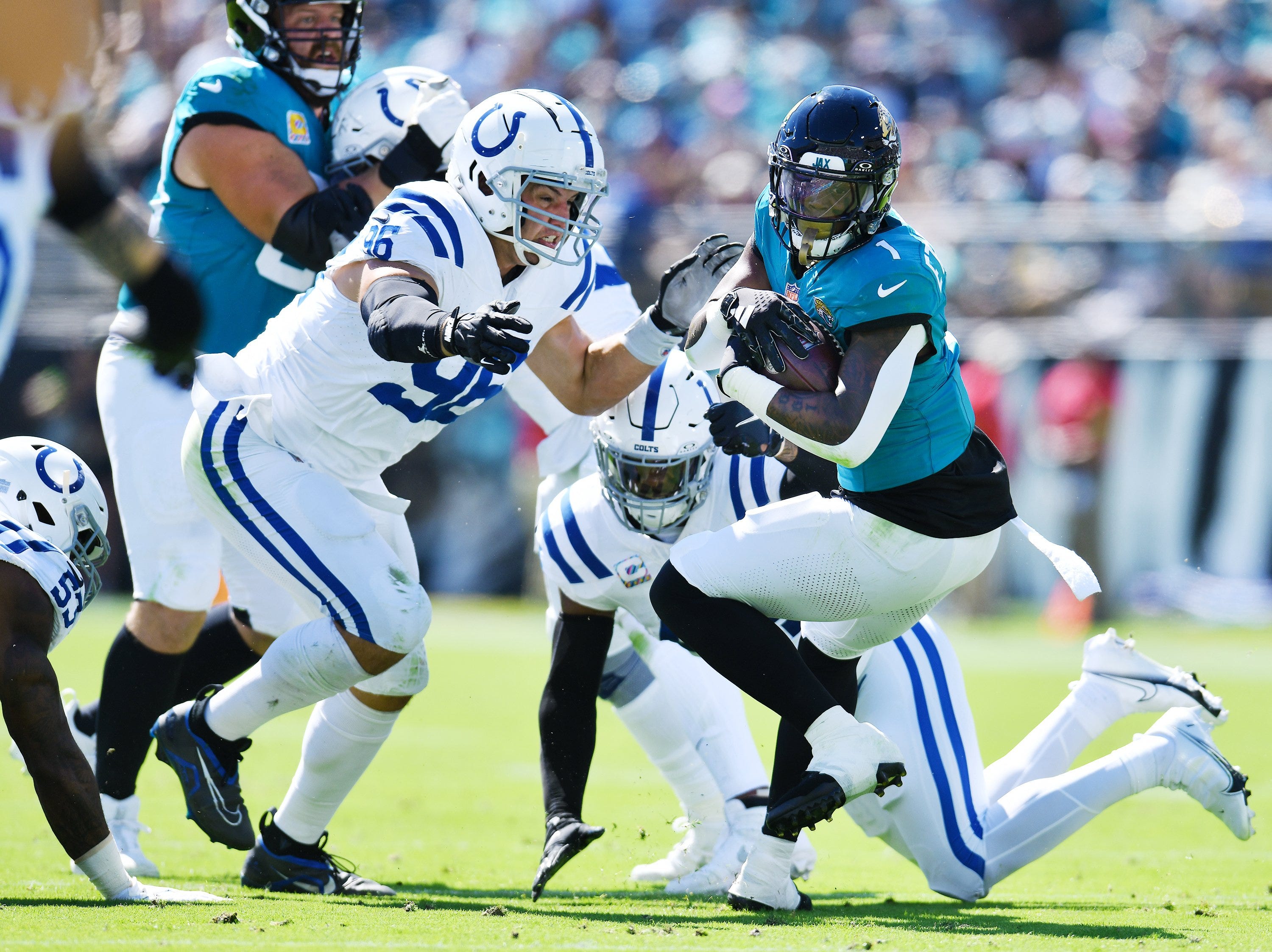 Indianapolis Colts defensive tackle Taven Bryan (96) and teammates try to stop Jacksonville Jaguars running back Travis Etienne Jr. (1) during first-quarter action. The Jacksonville Jaguars hosted the Indianapolis Colts at EverBank Stadium in Jacksonville, FL Sunday, October 15, 2023. The Jaguars ended the first half with a 21 to 6 lead.