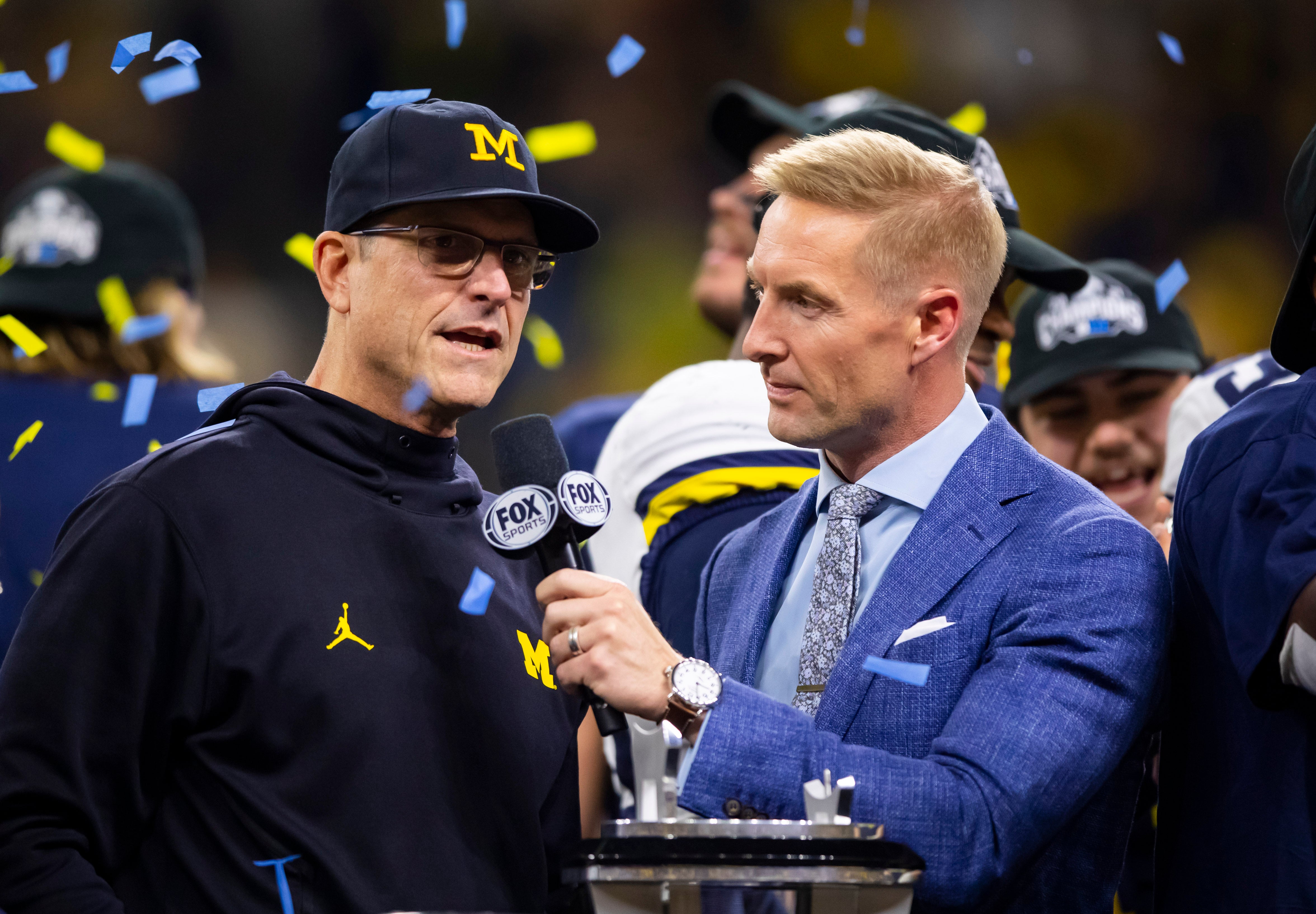 Dec 4, 2021; Indianapolis, IN, USA; Fox Sports analyst Joel Klatt interviews Michigan Wolverines head coach Jim Harbaugh after defeating the Iowa Hawkeyes in the Big Ten Conference championship game at Lucas Oil Stadium.