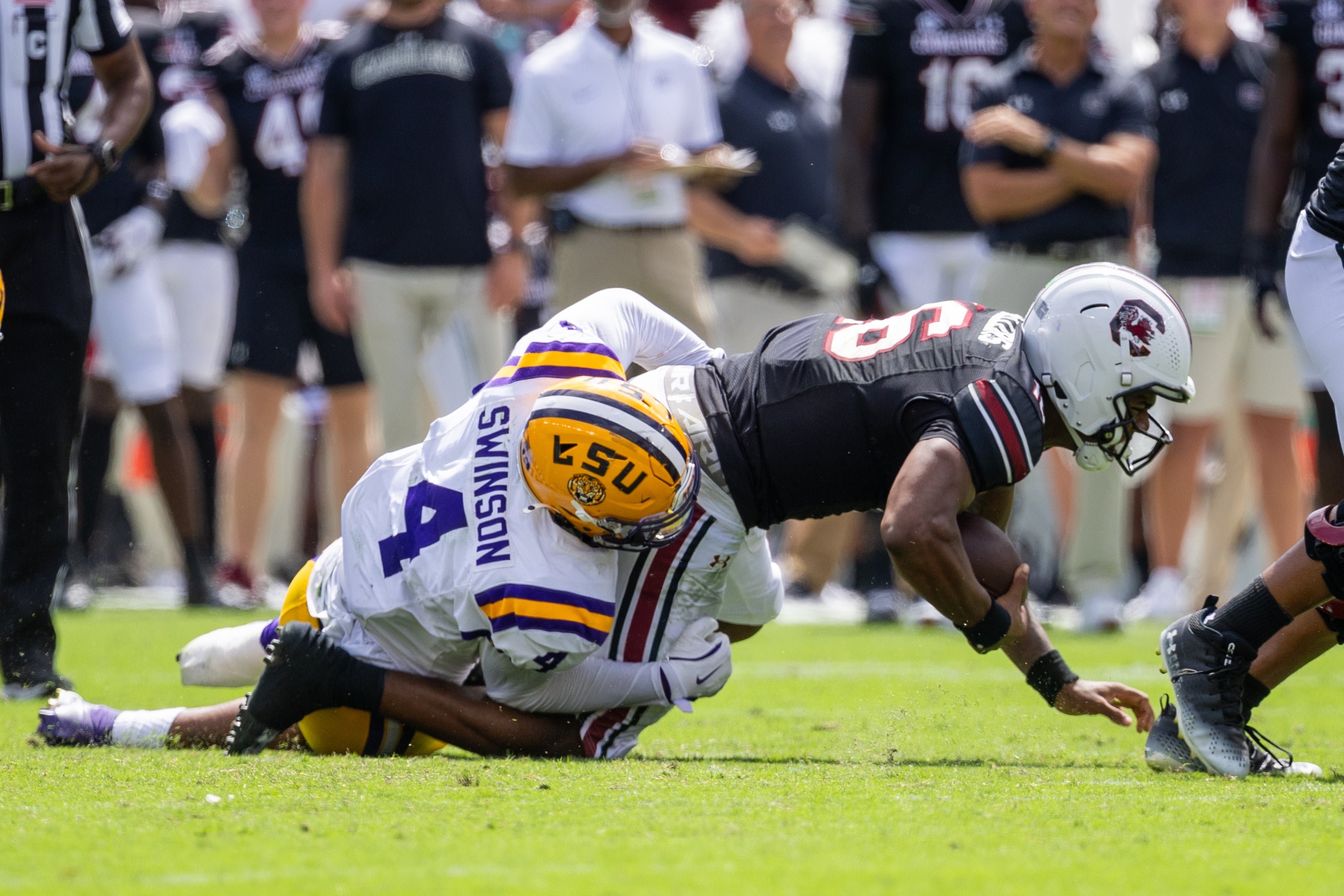 Sep 14, 2024; Columbia, South Carolina, USA; LSU Tigers defensive end Bradyn Swinson (4) sacks South Carolina Gamecocks quarterback LaNorris Sellers (16) during the second quarter at Williams-Brice Stadium.