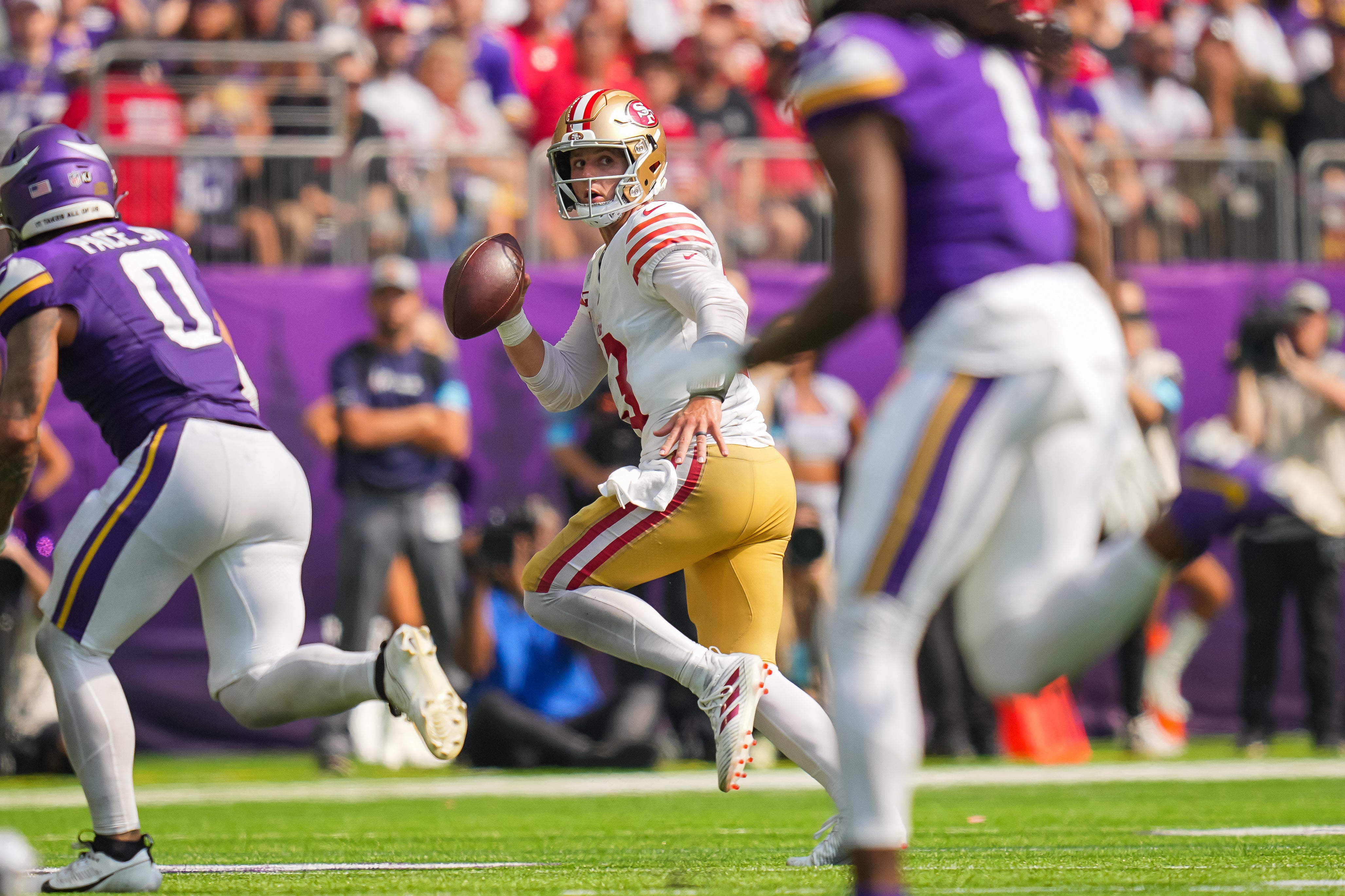 Sep 15, 2024; Minneapolis, Minnesota, USA; San Francisco 49ers quarterback Brock Purdy (13) scrambles against the Minnesota Vikings in the third quarter at U.S. Bank Stadium.