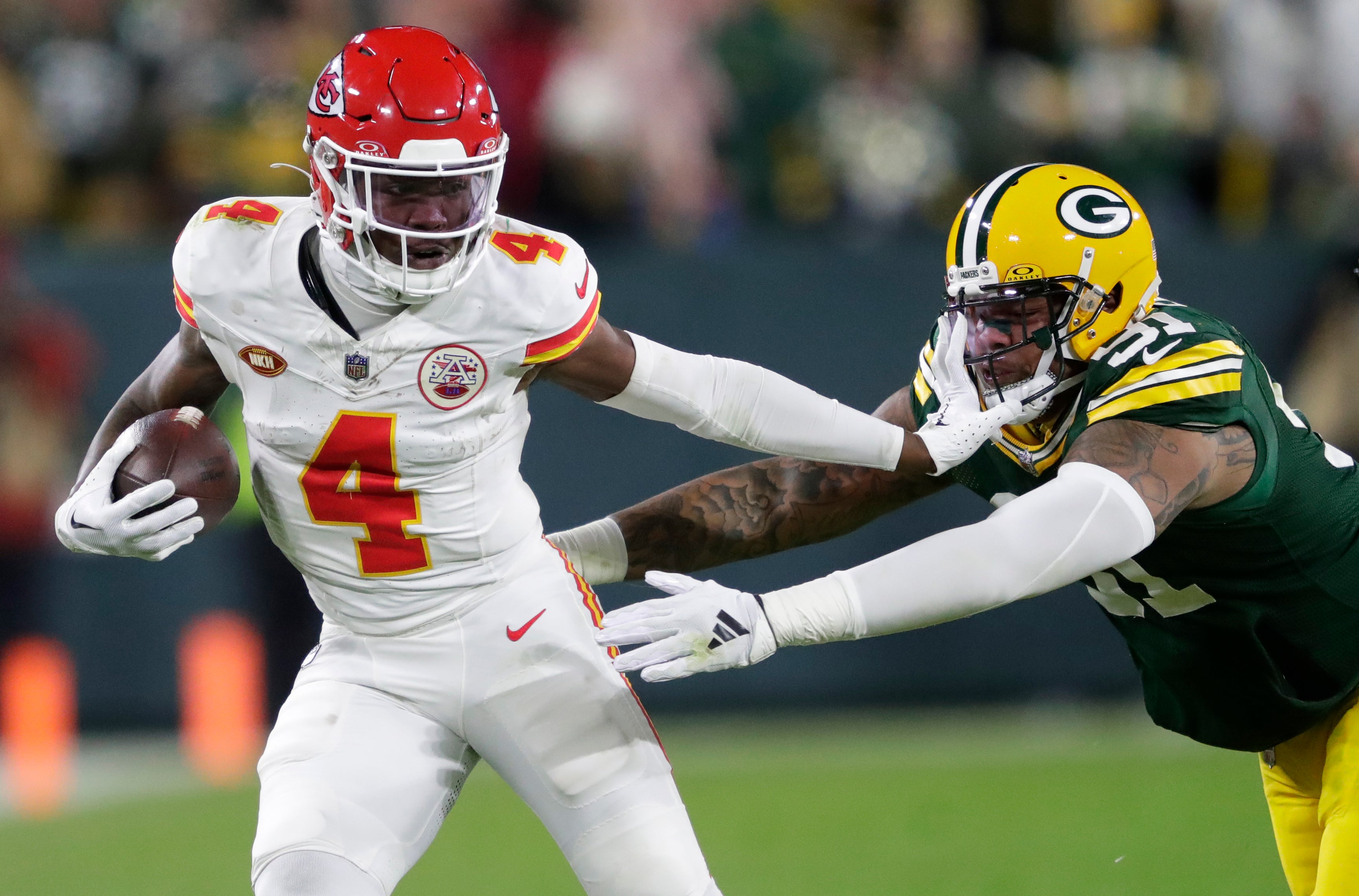 Dec 3, 2023; Green Bay, Wisconsin, USA; Kansas City Chiefs wide receiver Rashee Rice (4) stiff arms Green Bay Packers linebacker Preston Smith (91) during their football game at Lambeau Field.