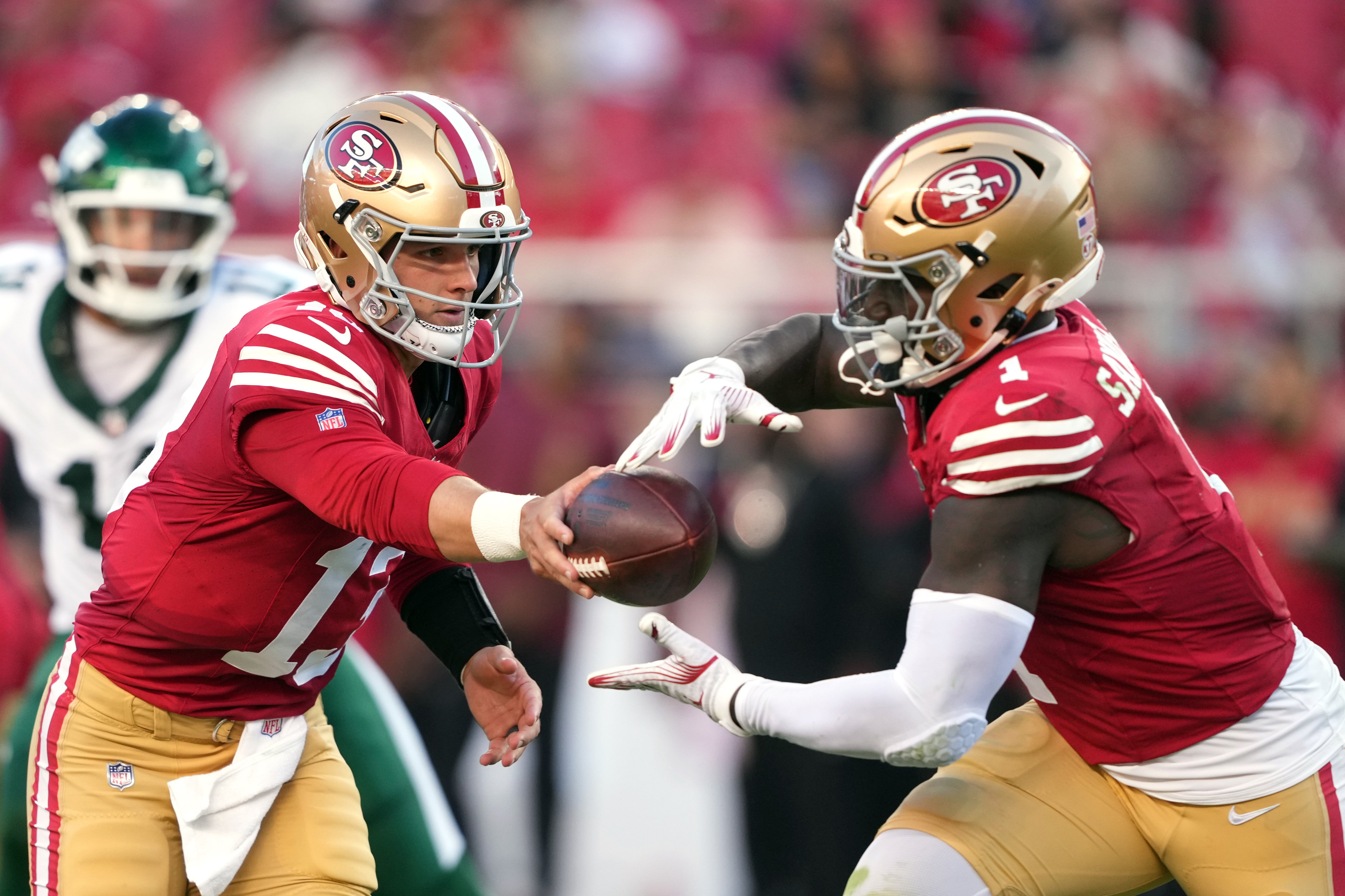 Sep 9, 2024; Santa Clara, California, USA; San Francisco 49ers quarterback Brock Purdy (left) hands off to wide receiver Deebo Samuel Sr. (right) during the second quarter against the New York Jets at Levi's Stadium.