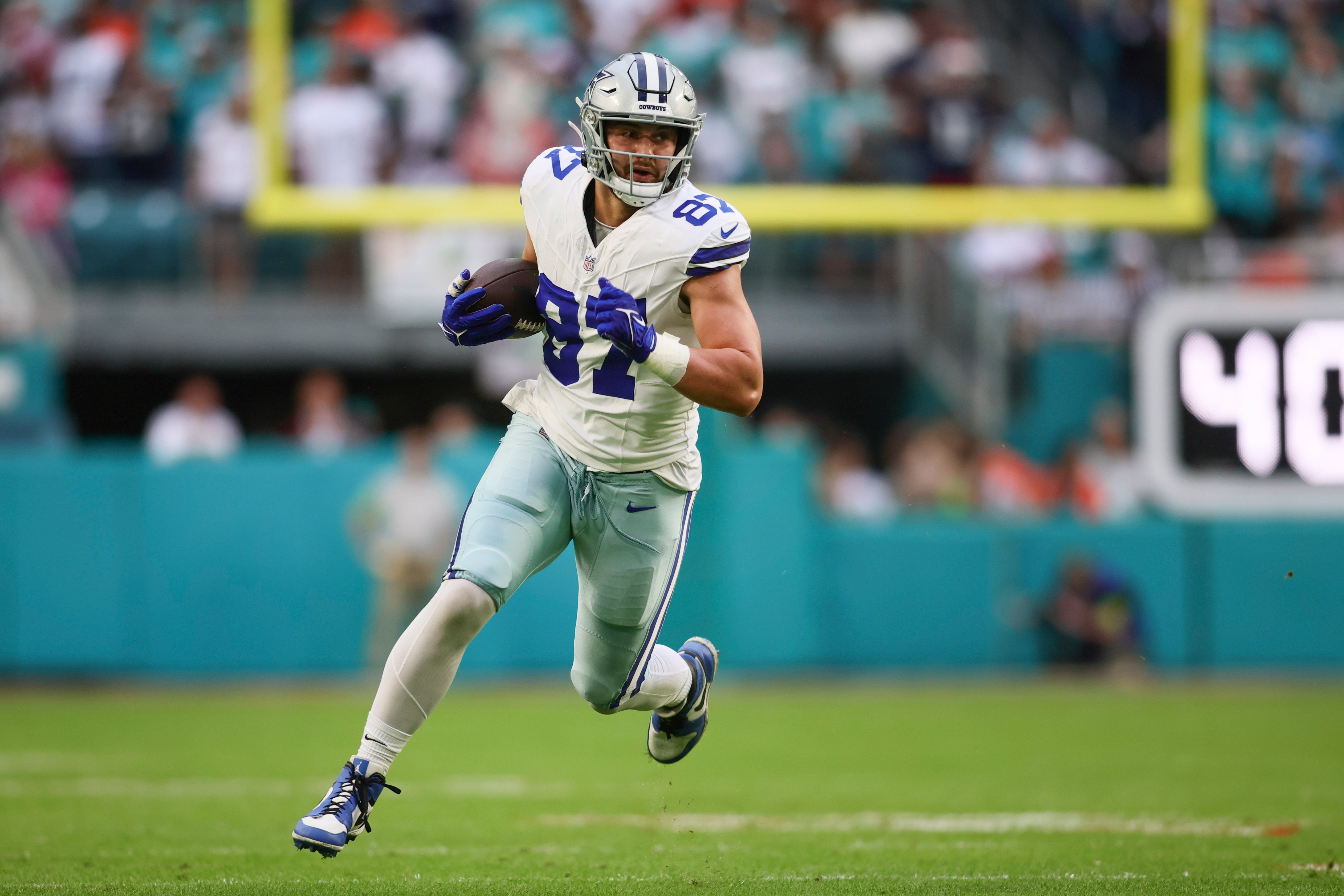 Dallas Cowboys tight end Jake Ferguson (87) runs with the football against the Miami Dolphins during the first quarter at Hard Rock Stadium.