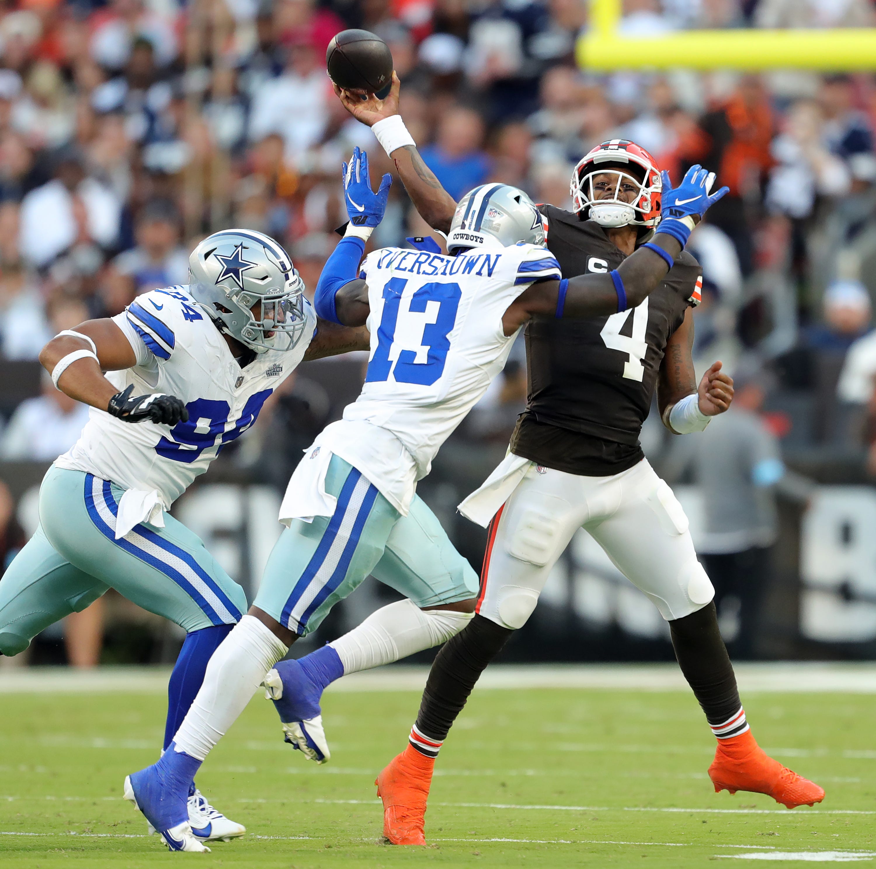 Cleveland Browns quarterback Deshaun Watson (4) fails to convert under pressure from Dallas Cowboys defensive end Marshawn Kneeland (94) and Dallas Cowboys linebacker DeMarvion Overshown (13) during the second half of an NFL football game at Huntington Bank Field, Sunday, Sept. 8, 2024, in Cleveland, Ohio.