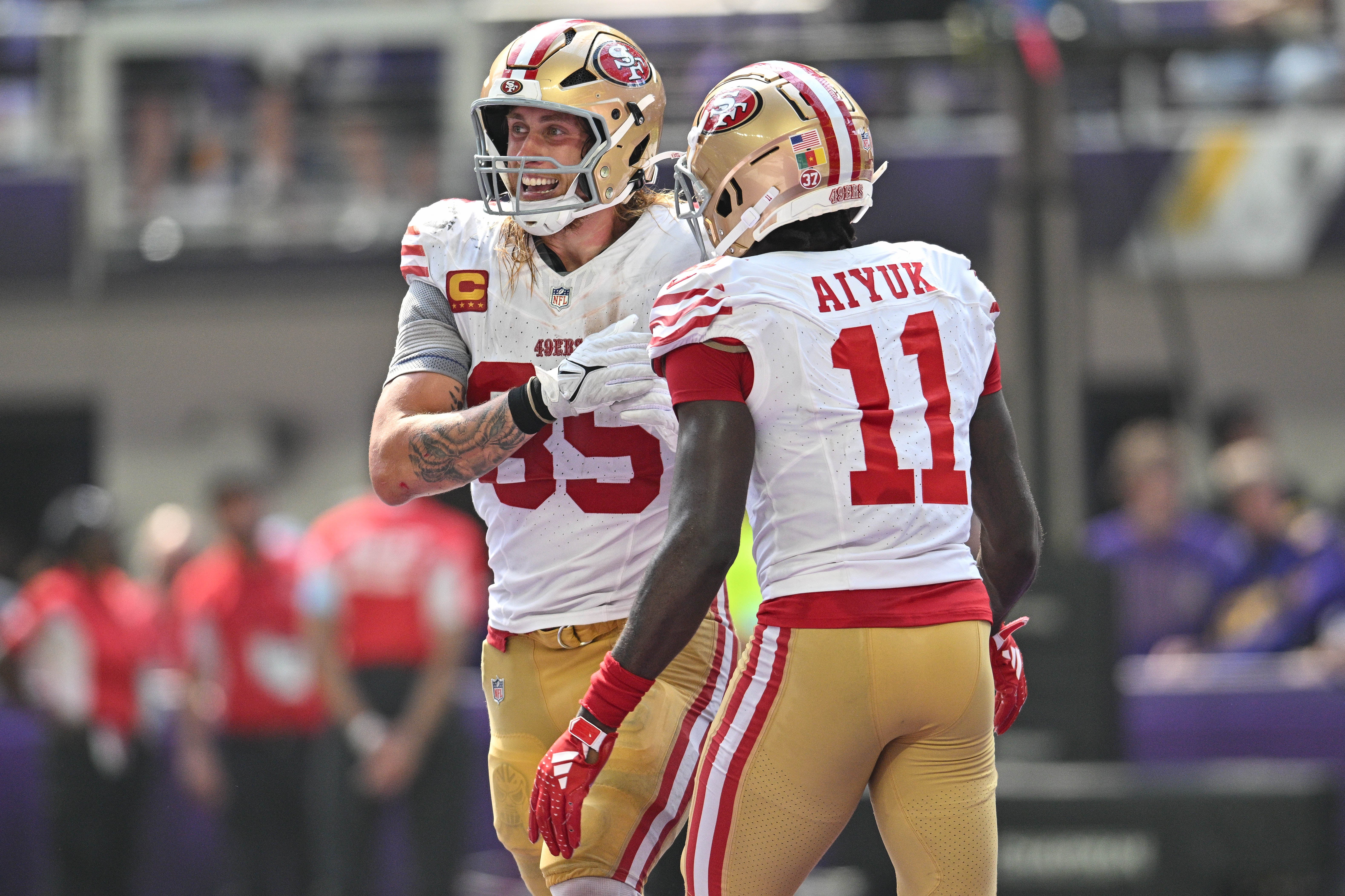 Sep 15, 2024; Minneapolis, Minnesota, USA; San Francisco 49ers tight end George Kittle (85) and wide receiver Brandon Aiyuk (11) react after a touchdown by Kittle during the second quarter against the Minnesota Vikings U.S. Bank Stadium.