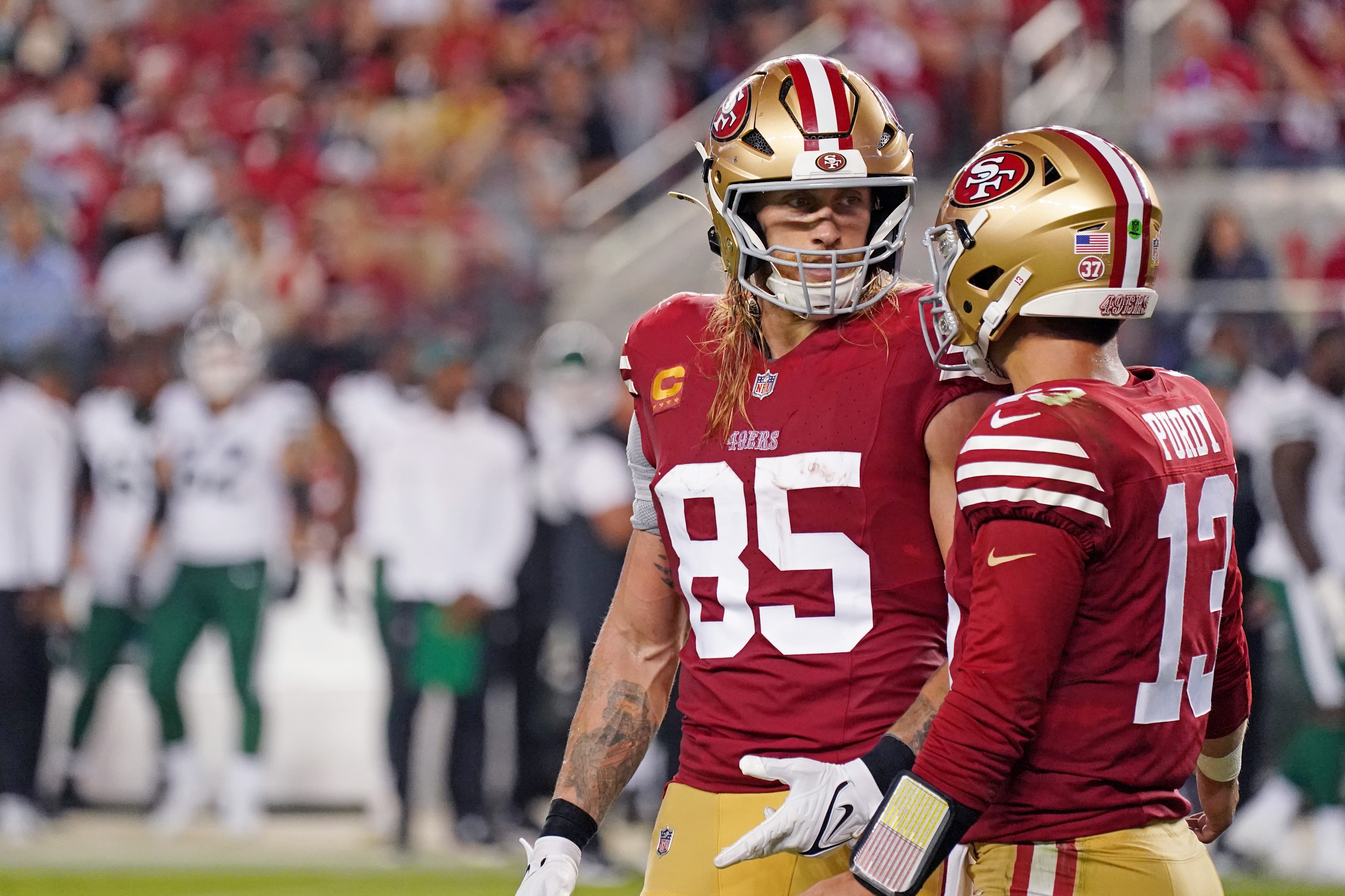 San Francisco 49ers tight end George Kittle (85) chats with San Francisco 49ers quarterback Brock Purdy (13) while facing the New York Jets in the fourth quarter at Levi's Stadium.