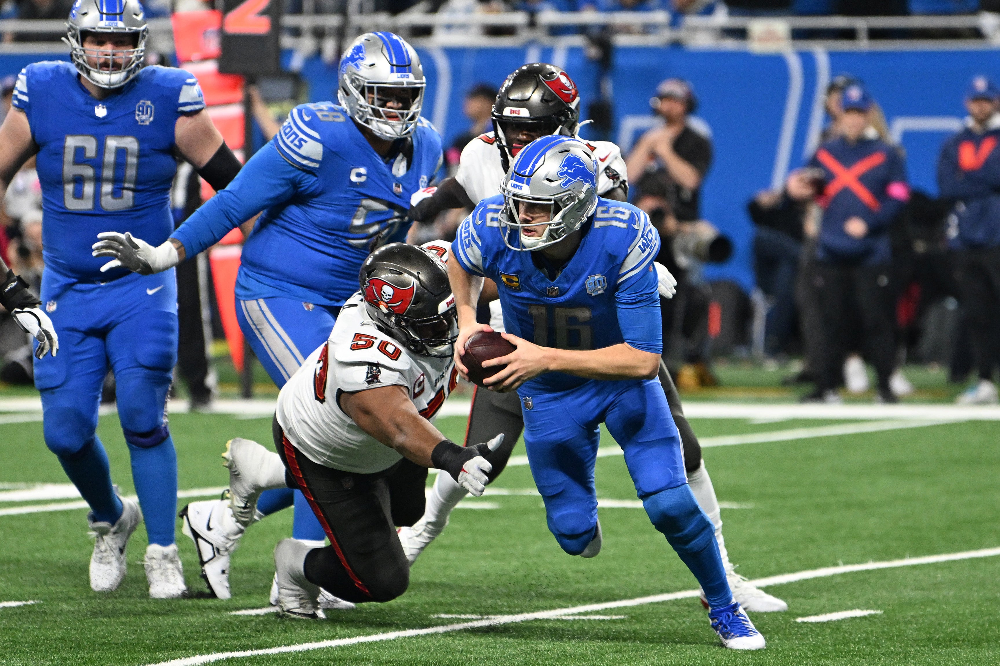 Jan 21, 2024; Detroit, Michigan, USA; Detroit Lions quarterback Jared Goff (16) runs with the ball against Tampa Bay Buccaneers defensive tackle Vita Vea (50) during the second half in a 2024 NFC divisional round game at Ford Field.