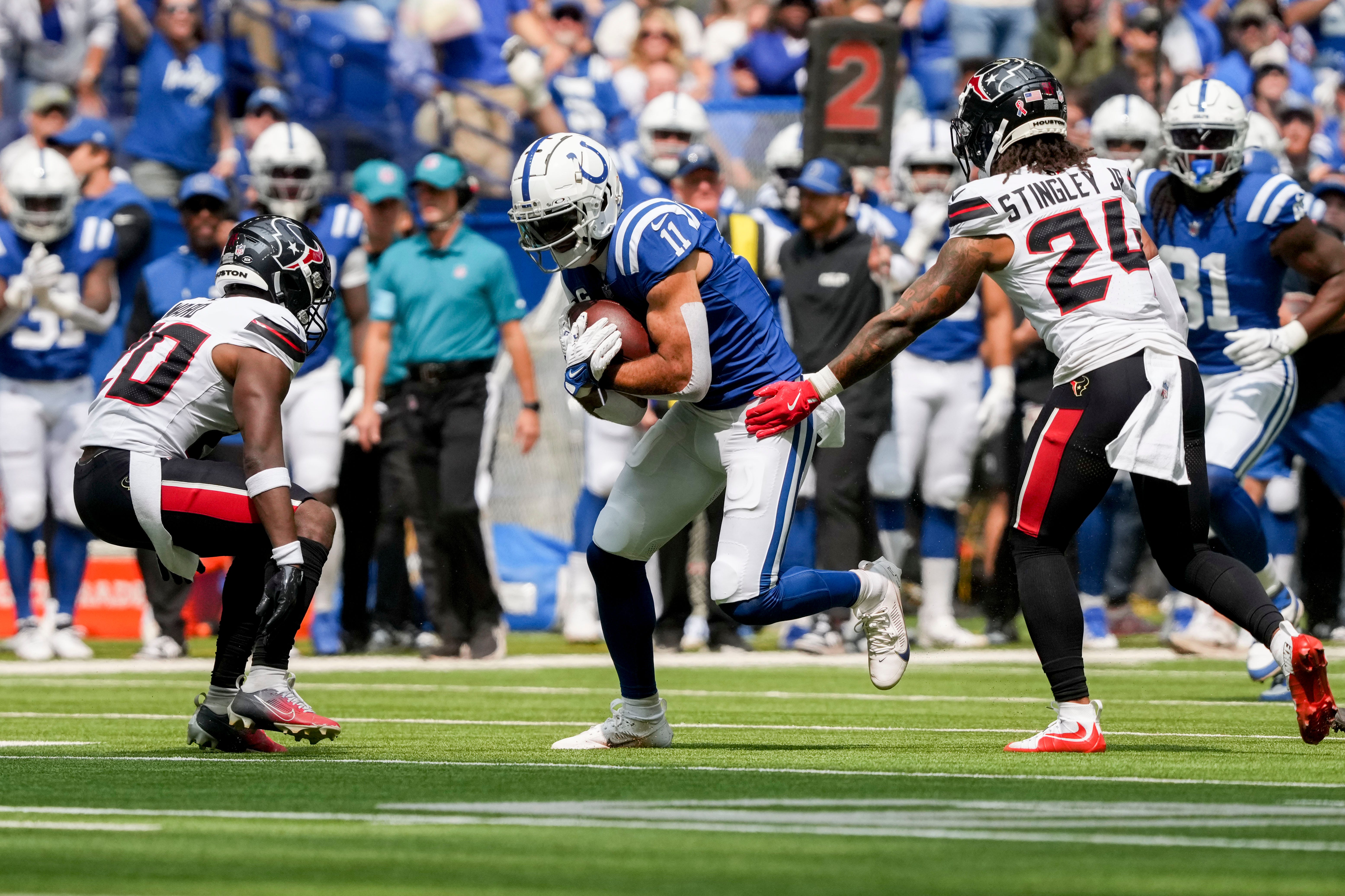 Indianapolis Colts wide receiver Michael Pittman Jr. (11) looks to move past Houston Texans safety Jimmie Ward (20) and Houston Texans cornerback Derek Stingley Jr. (24) on Sunday, Sept. 8, 2024, during a game against the Houston Texans at Lucas Oil Stadium in Indianapolis.