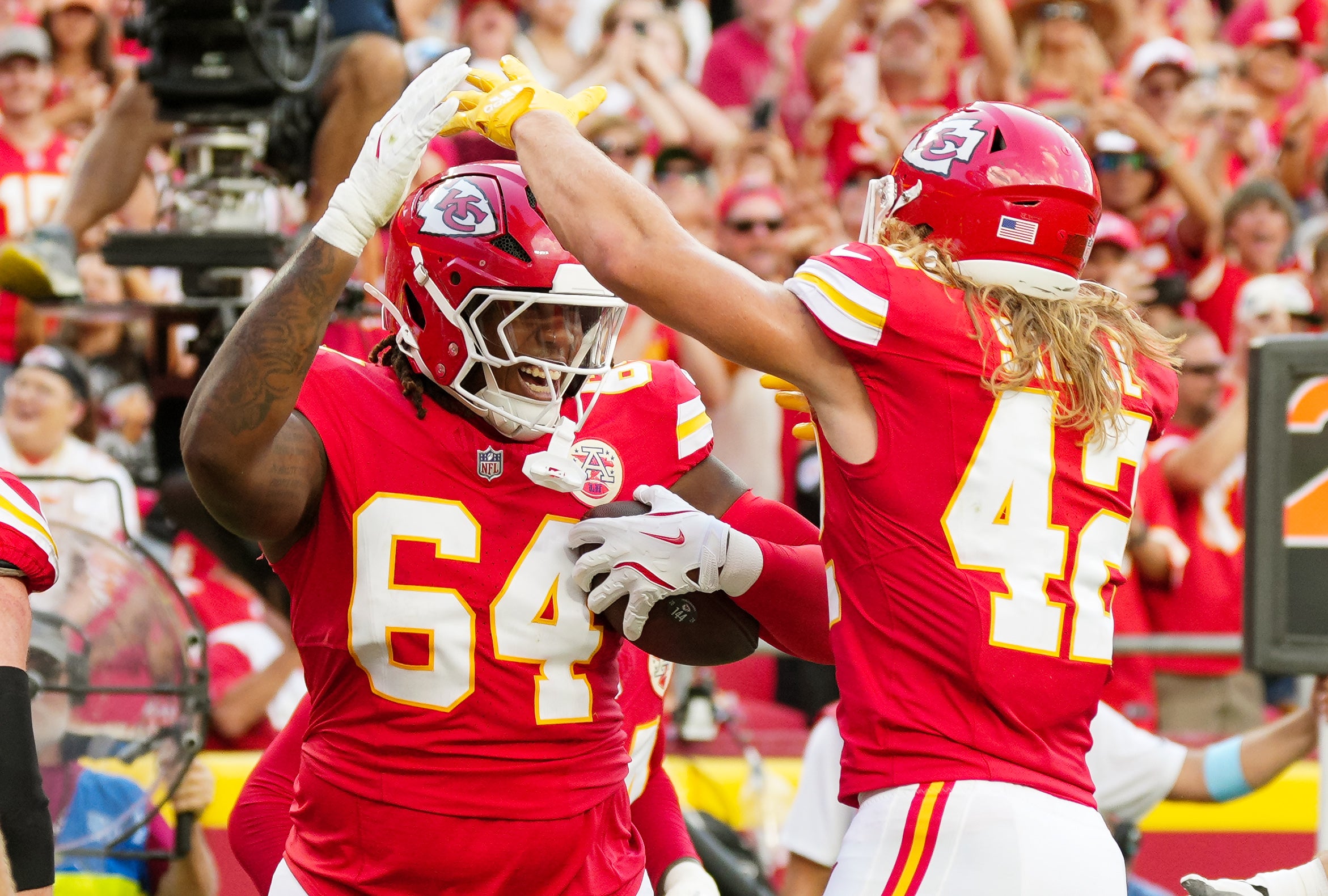 Sep 15, 2024; Kansas City, Missouri, USA; Kansas City Chiefs offensive tackle Wanya Morris (64) celebrates with running back Carson Steele (42) after scoring a touchdown during the second half against the Cincinnati Bengals at GEHA Field at Arrowhead Stadium.