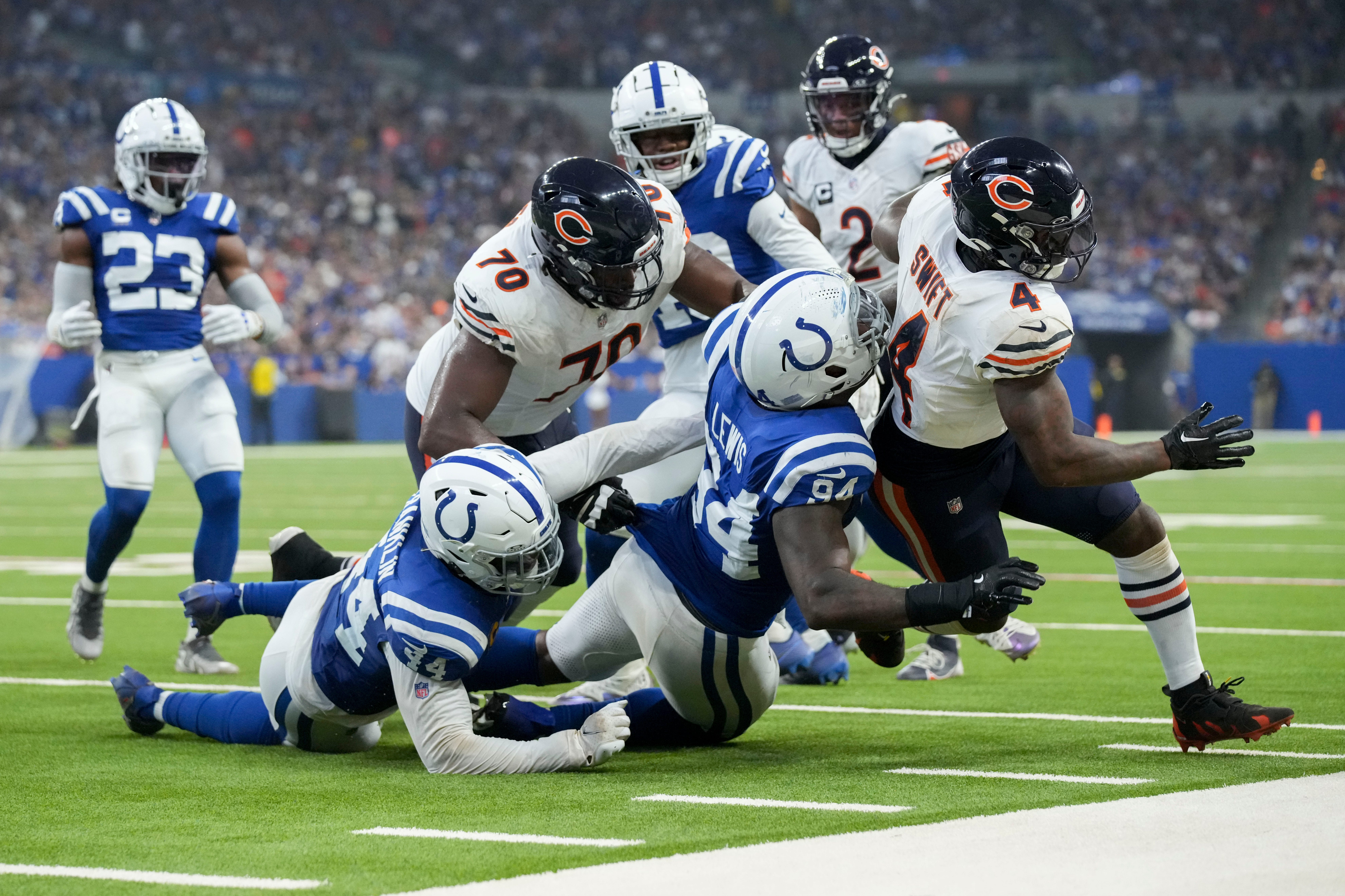 Indianapolis Colts defensive end Tyquan Lewis (94) works to bring down Chicago Bears running back D'Andre Swift (4) on Sunday, Sept. 22, 2024, during a game against the Chicago Bears at Lucas Oil Stadium in Indianapolis.