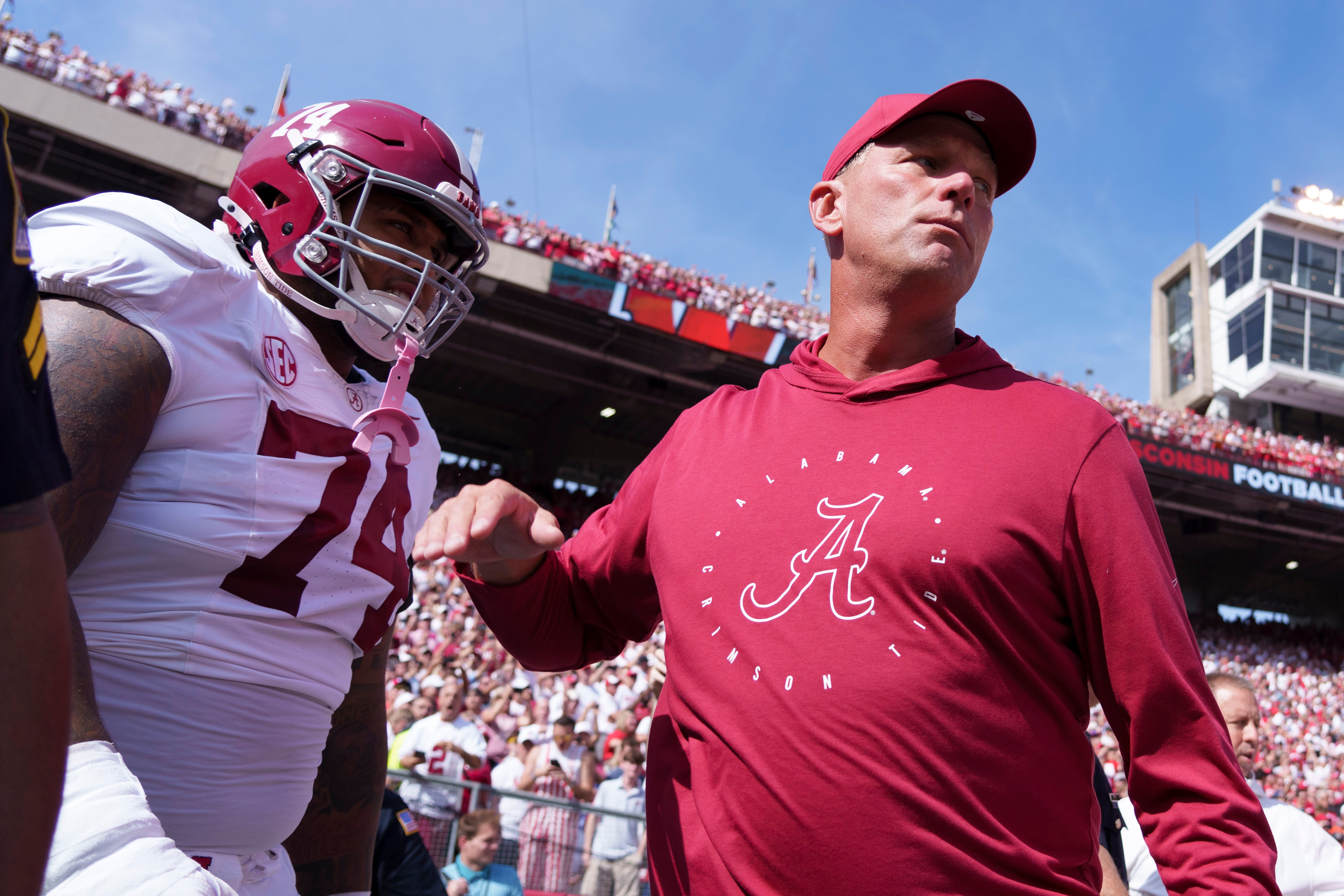 Sep 14, 2024; Madison, Wisconsin, USA; Alabama Crimson Tide head coach Kalen DeBoer greets offensive linenam Kadyn Proctor (74) prior to the game against the Wisconsin Badgers at Camp Randall Stadium.
