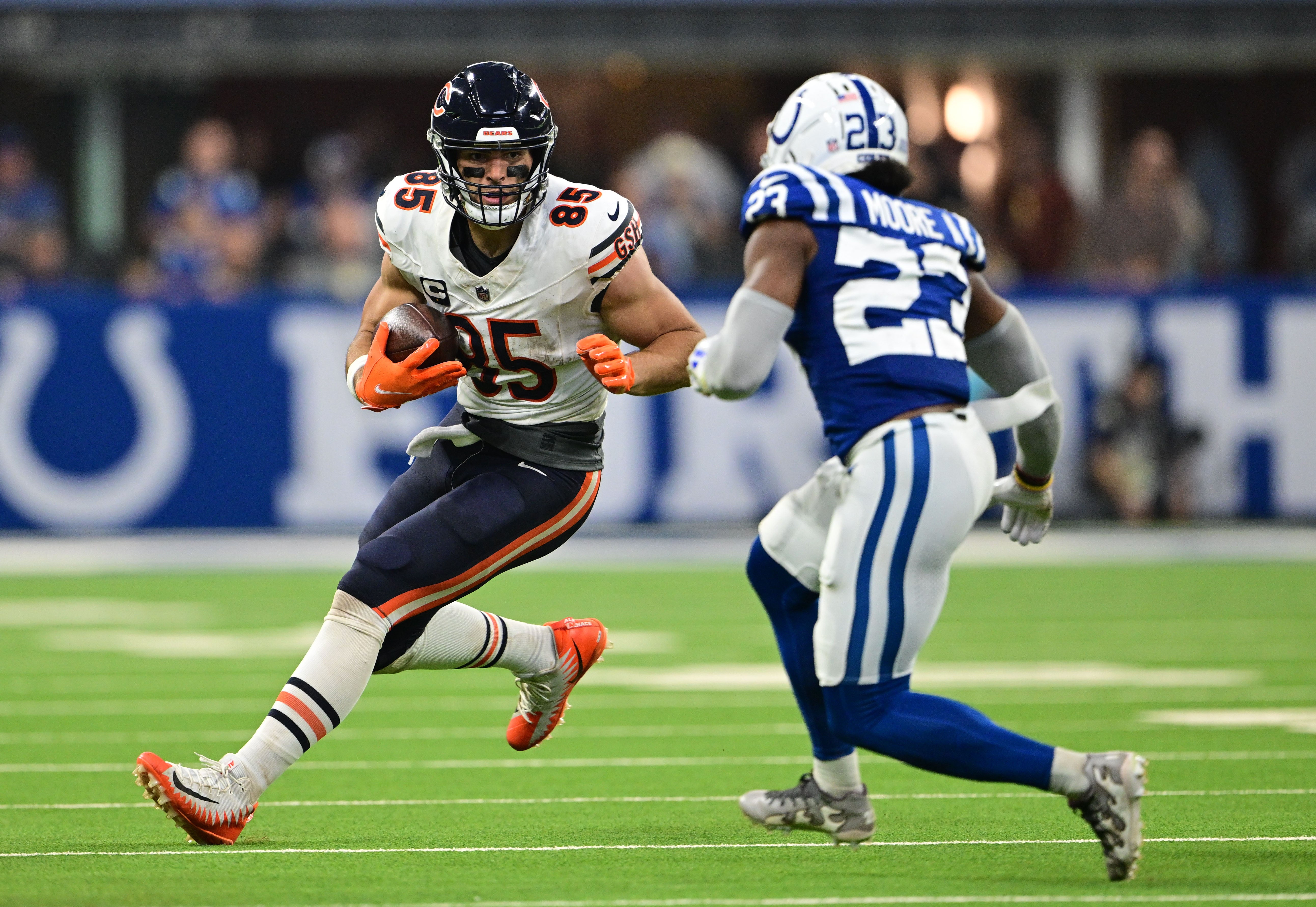 Sep 22, 2024; Indianapolis, Indiana, USA; Chicago Bears tight end Cole Kmet (85) looks to run past Indianapolis Colts cornerback Kenny Moore II (23) during the second half at Lucas Oil Stadium.