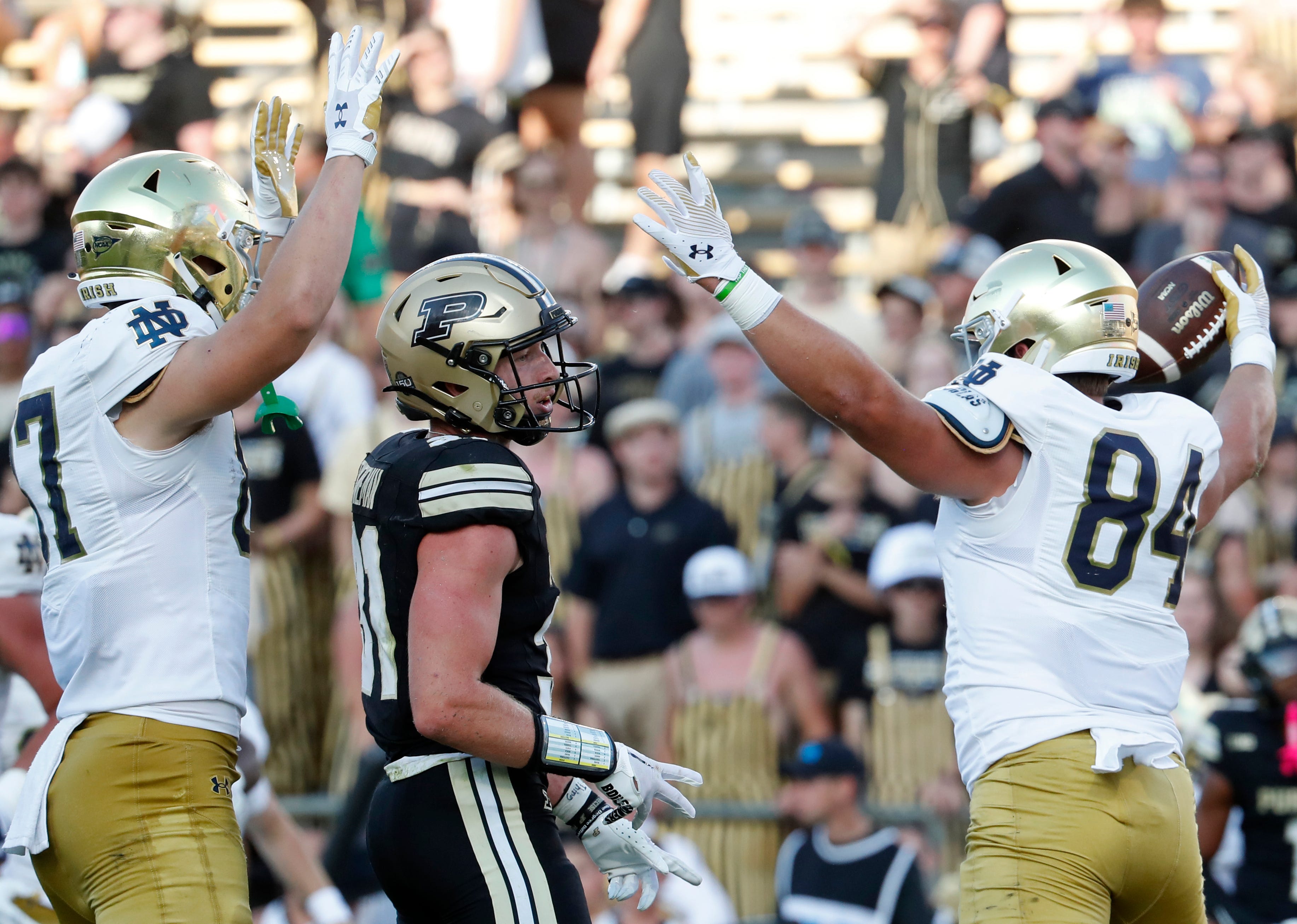 Notre Dame Fighting Irish tight end Cooper Flanagan (87) and Notre Dame Fighting Irish tight end Kevin Bauman (84) celebrates in front of Purdue Boilermakers defensive back Dillon Thieneman (31) after a Notre Dame Fighting Irish touchdown Saturday, Sept. 14, 2024, during the NCAA football game at Ross-Ade Stadium in West Lafayette, Ind. Notre Dame Fighting Irish won 66-7.