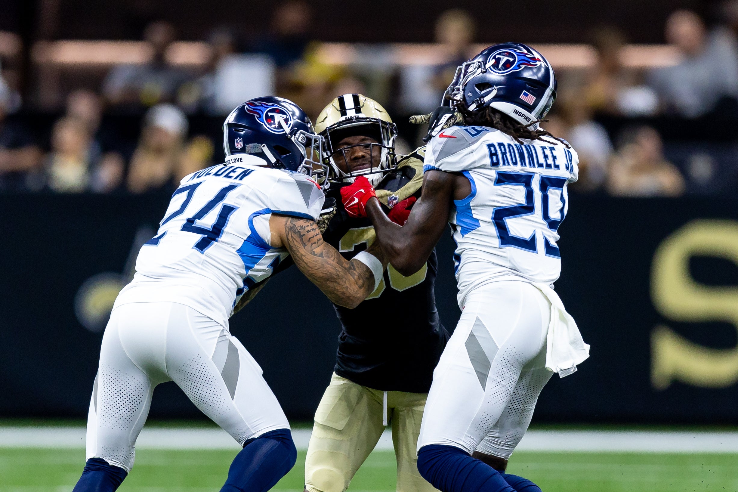 New Orleans Saints cornerback Rejzohn Wright (28) is blocked on a kick off by Tennessee Titans cornerback Elijah Molden (24) and cornerback Jarvis Brownlee Jr. (29) during the first half at Caesars Su... Stephen Lew-Imagn Images