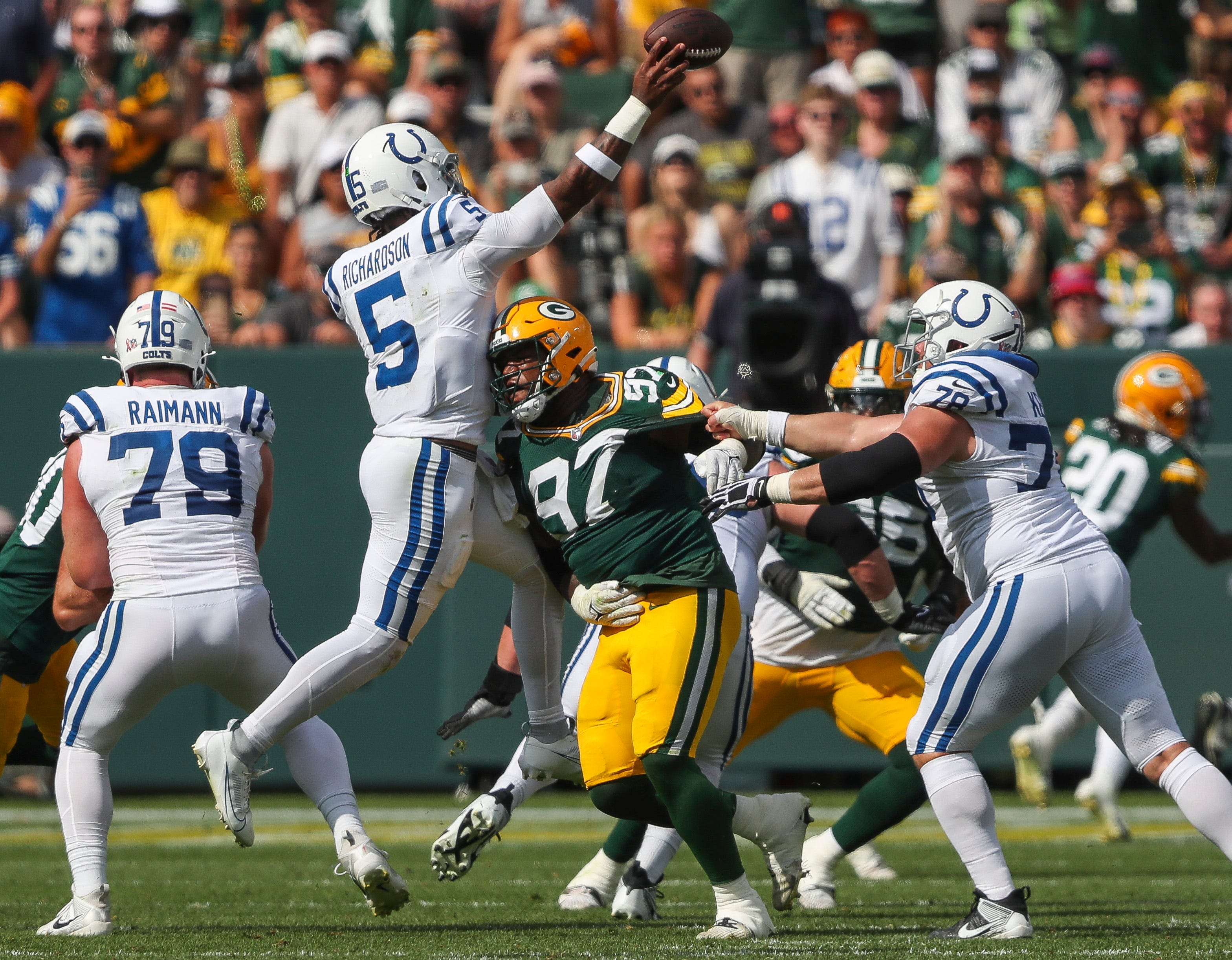 Green Bay Packers defensive tackle Kenny Clark (97) pressures Indianapolis Colts quarterback Anthony Richardson (5) as Richardson passes the ball on Sunday, September 15, 2024, at Lambeau Field in Green Bay, Wis. The Packers won the game, 16-10.