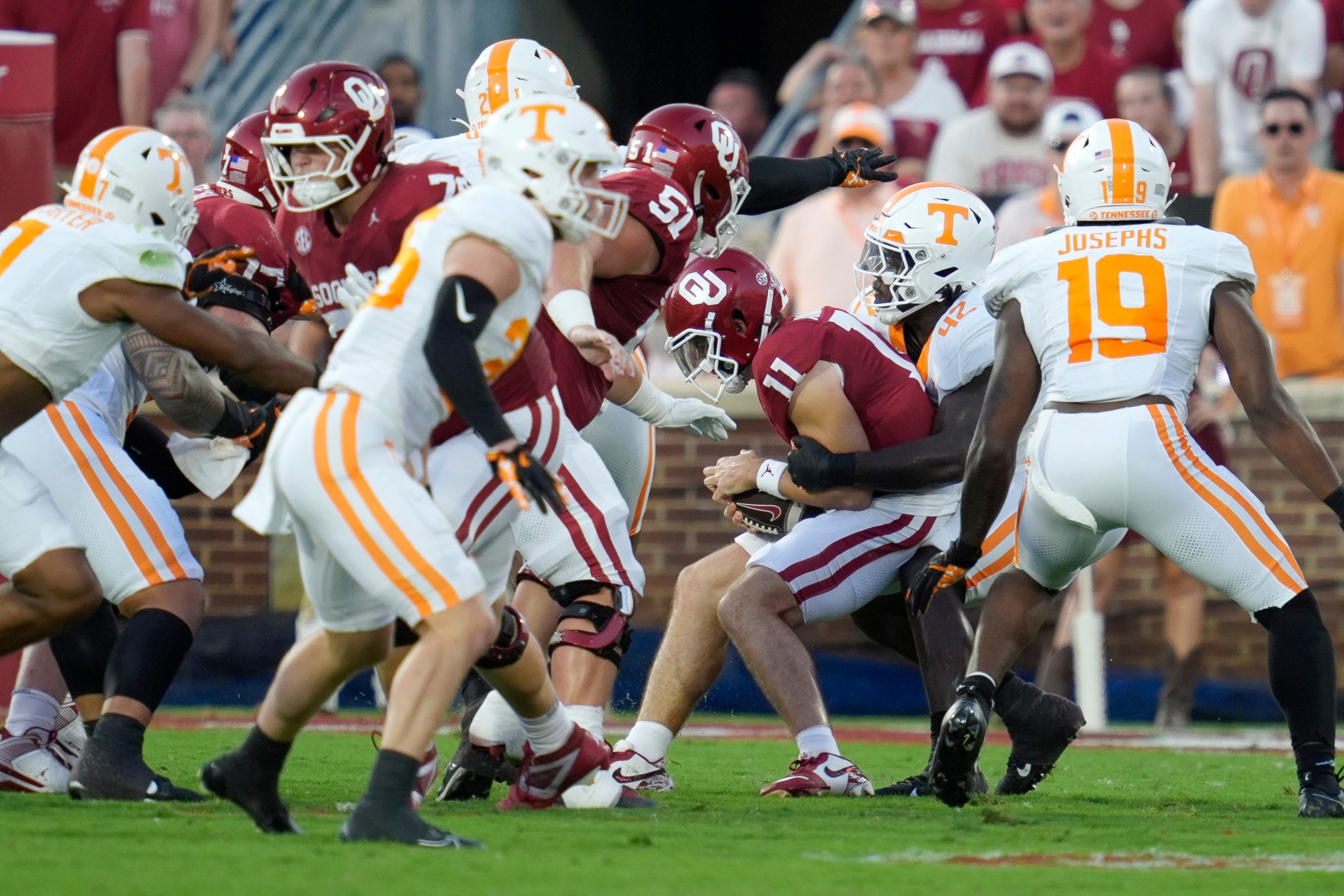 Oklahoma Sooners quarterback Jackson Arnold (11) is brought down by Tennessee Volunteers defensive lineman Tyre West (42) during a college football game between the University of Oklahoma Sooners (OU) and the Tennessee Volunteers at Gaylord Family - Oklahoma Memorial Stadium in Norman, Okla., Saturday, Sept. 21, 2024.