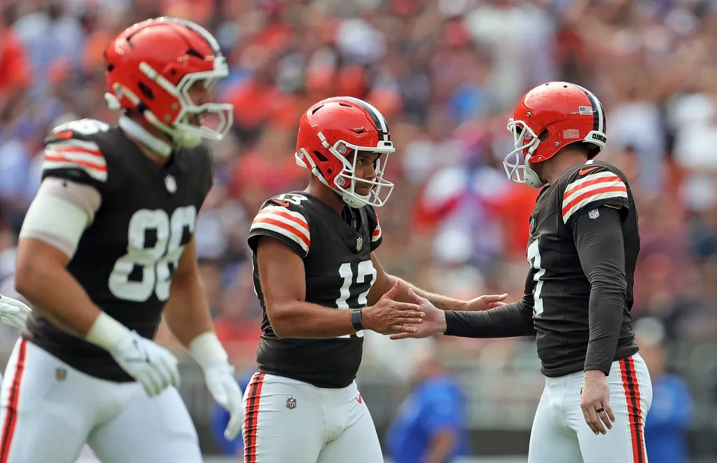Cleveland Browns punter Corey Bojorquez (13) celebrates with place kicker Dustin Hopkins (7) during the first half of an NFL football game at Huntington Bank Field