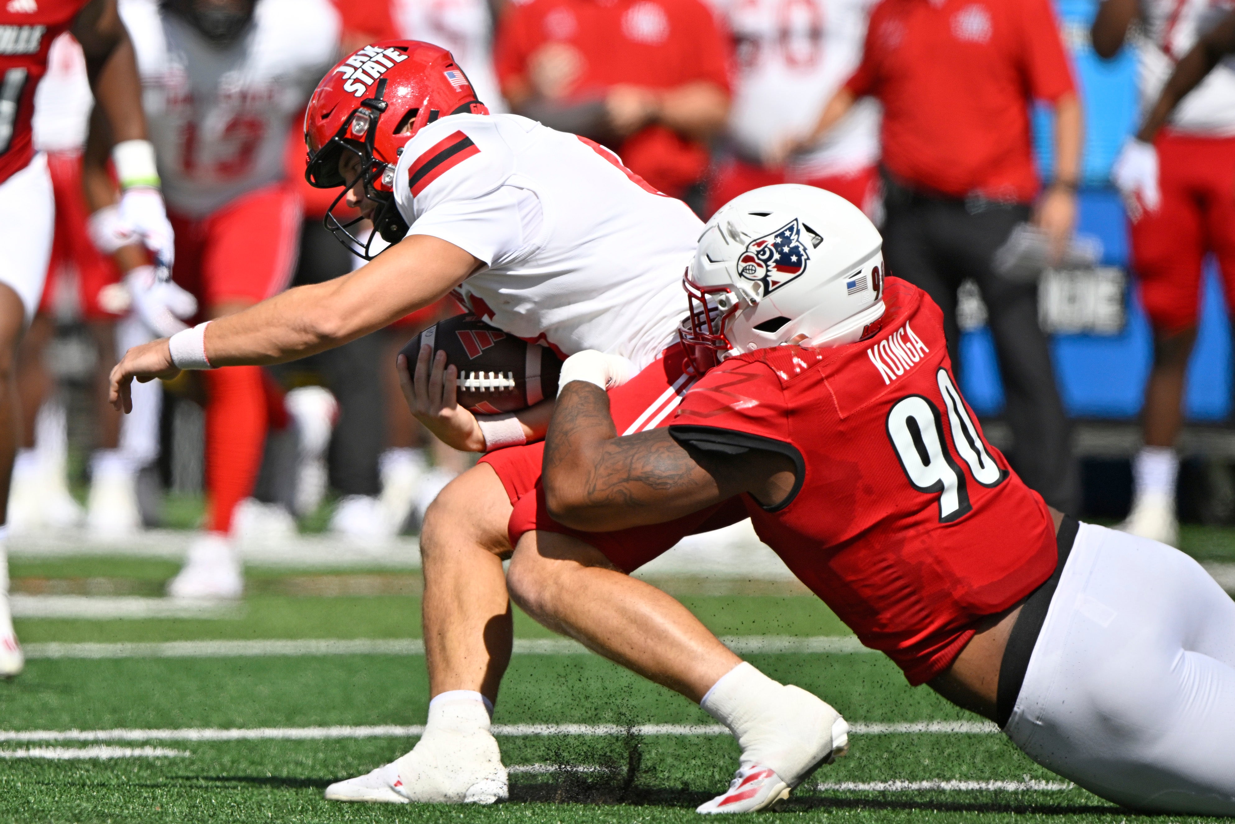  Louisville Cardinals defensive lineman Rene Konga (90) sacks Jacksonville State Gamecocks quarterback Tyler Huff (6) during the first quarter at L&N Federal Credit Union Stadium.