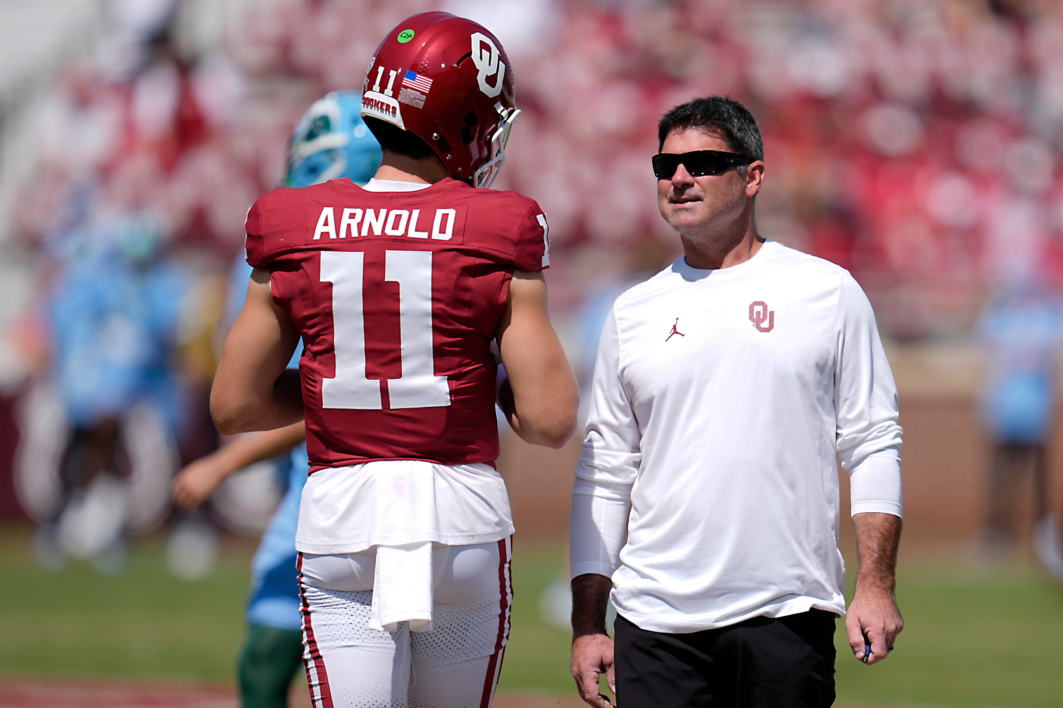 Oklahoma offensive coordinator Seth Littrell talks with quarterback Jackson Arnold (11) before a college football game between the University of Oklahoma Sooners (OU) and the Tulane Green Wave at Gaylord Family - Oklahoma Memorial Stadium in Norman, Okla., Saturday, Sept. 14, 2024.