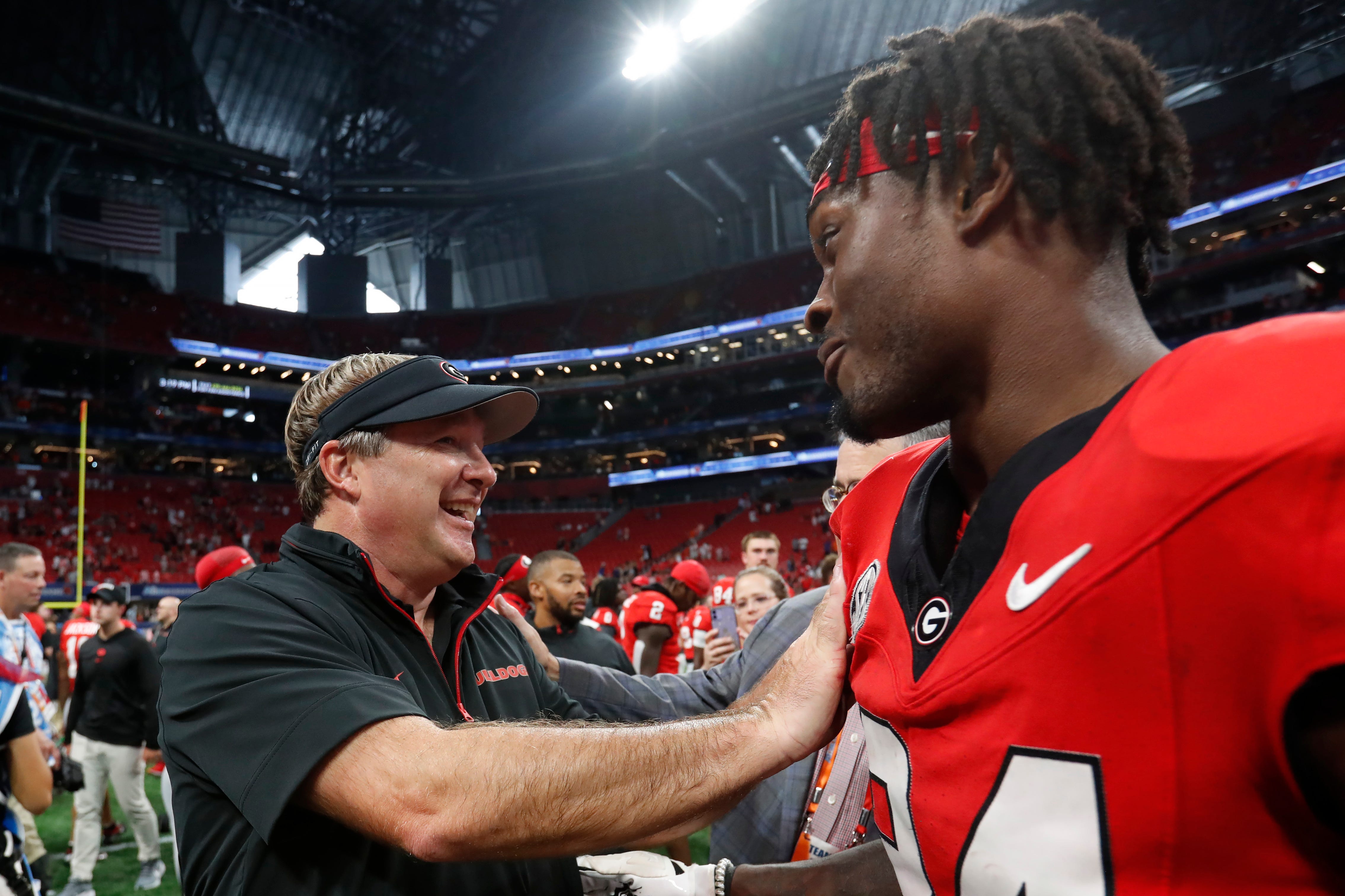 Georgia coach Kirby Smart celebrates with Georgia defensive back Malaki Starks (24) after the NCAA Aflac Kickoff Game in Atlanta, on Saturday, Aug. 31, 2024. Georgia won 34-3.