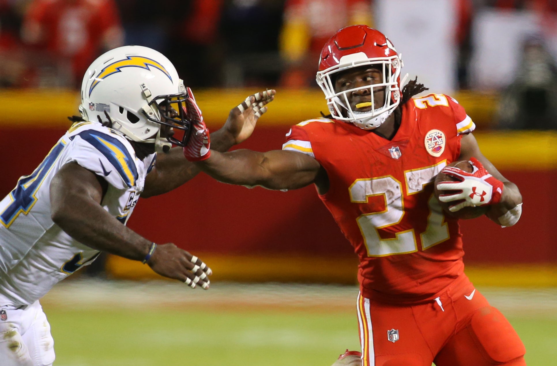 Dec 16, 2017; Kansas City, MO, USA; Kansas City Chiefs running back Kareem Hunt (27) stiff arms Los Angeles Chargers linebacker Melvin Ingram (54) in the second half at Arrowhead Stadium.
