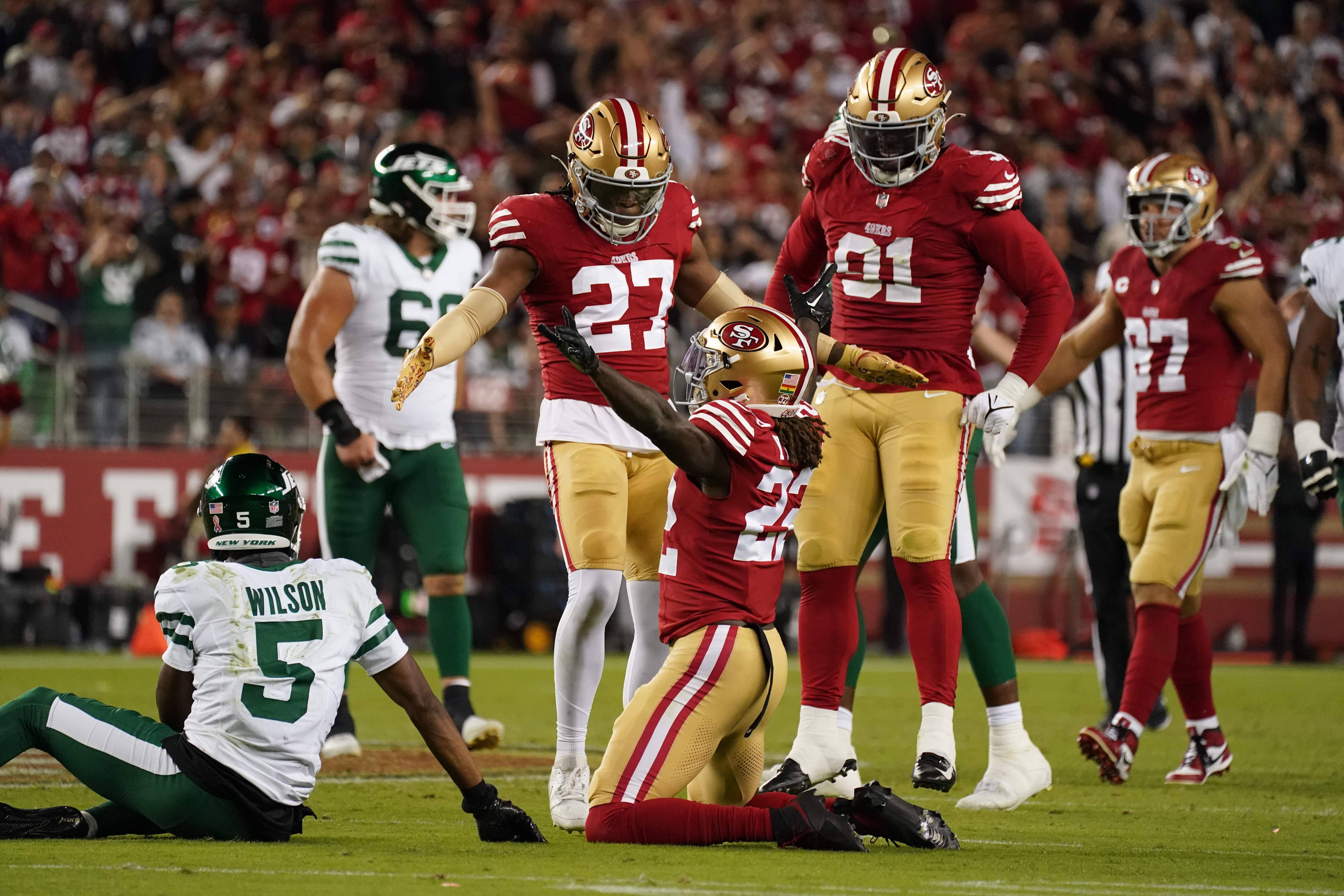 San Francisco 49ers cornerback Isaac Yiadom (22) breaks up a fourth down pass to New York Jets wide receiver Garrett Wilson (5) in the fourth quarter against the New York Jets at Levi's Stadium. San Francisco 49ers safety Ji'Ayir Brown (27), and San Francisco 49ers defensive tackle Sam Okuayinonu (91) stand nearby.
