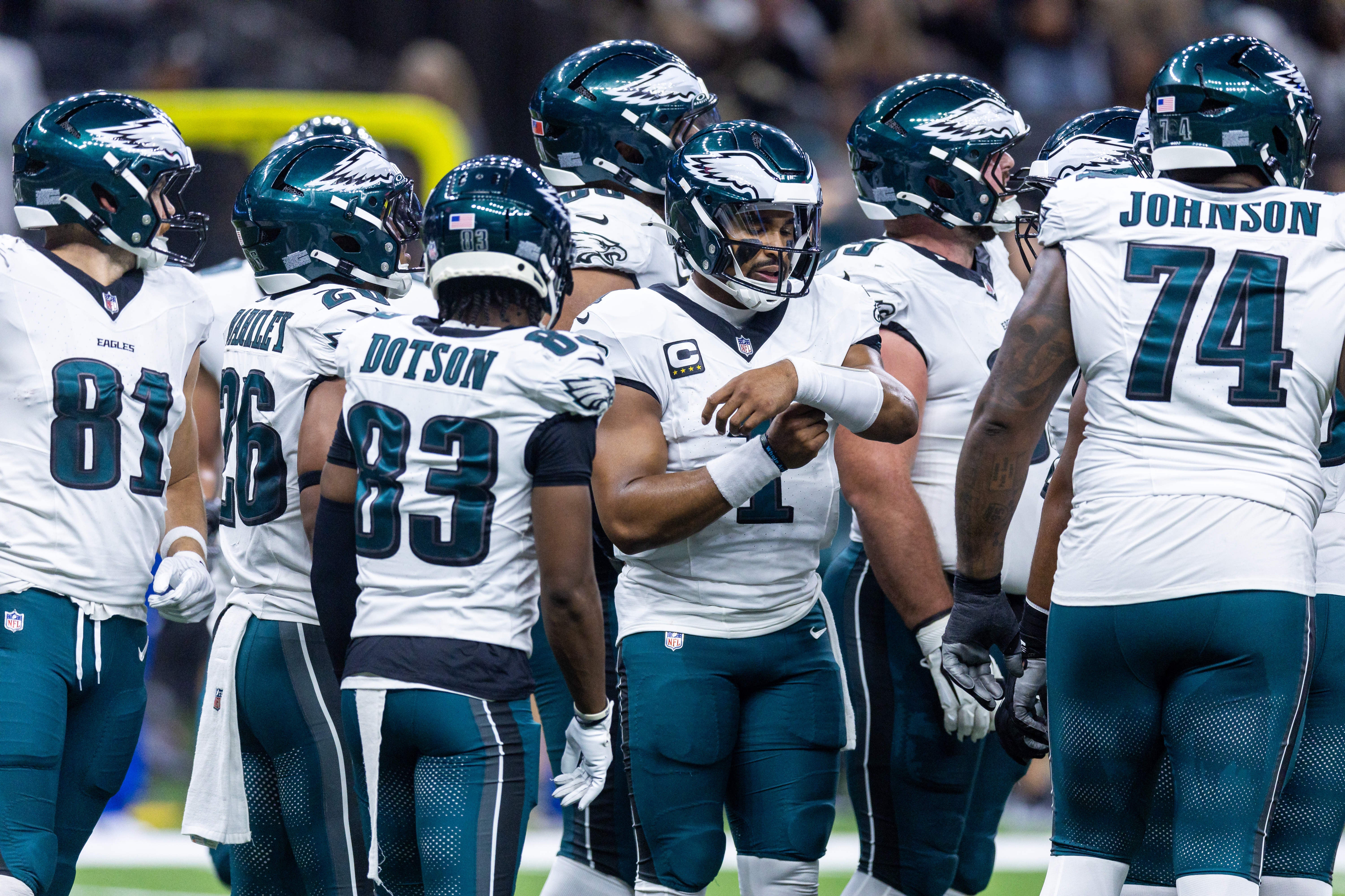 Philadelphia Eagles quarterback Jalen Hurts (1) calls a play in the huddle against the New Orleans Saints during the first half at Caesars Superdome.